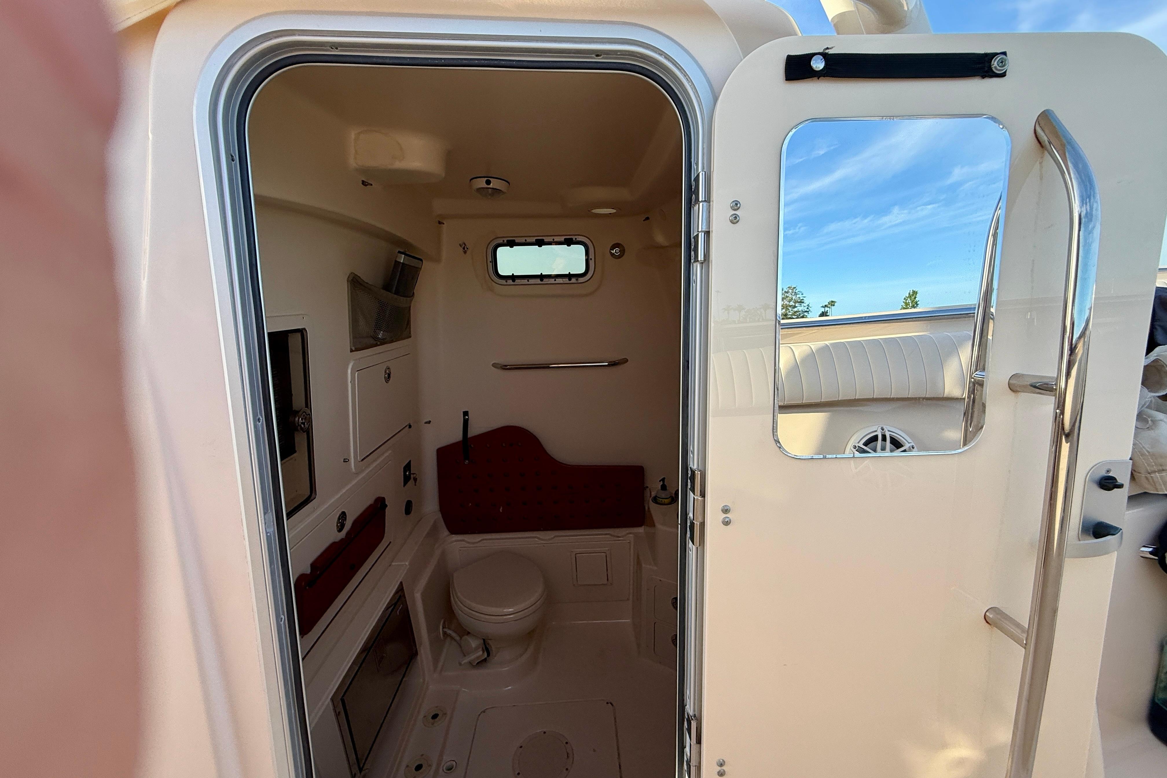 Interior view of 2012 Grady-White Canyon 336 boat bathroom with open door.