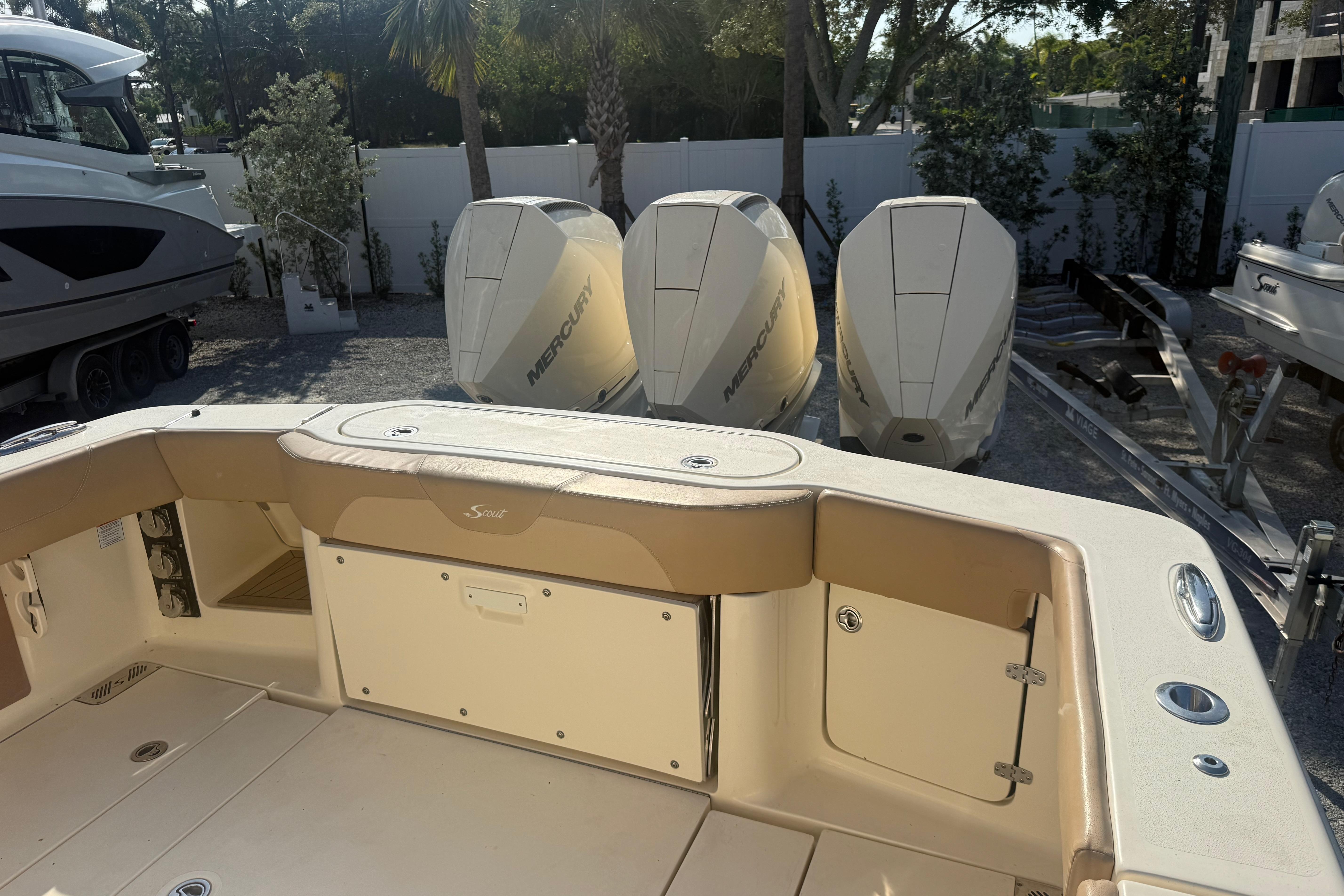 2022 Scout 355 LXF boat with Mercury engines, docked outdoors.