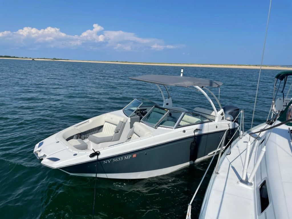 2020 Cobalt SC23 boat anchored on calm water.