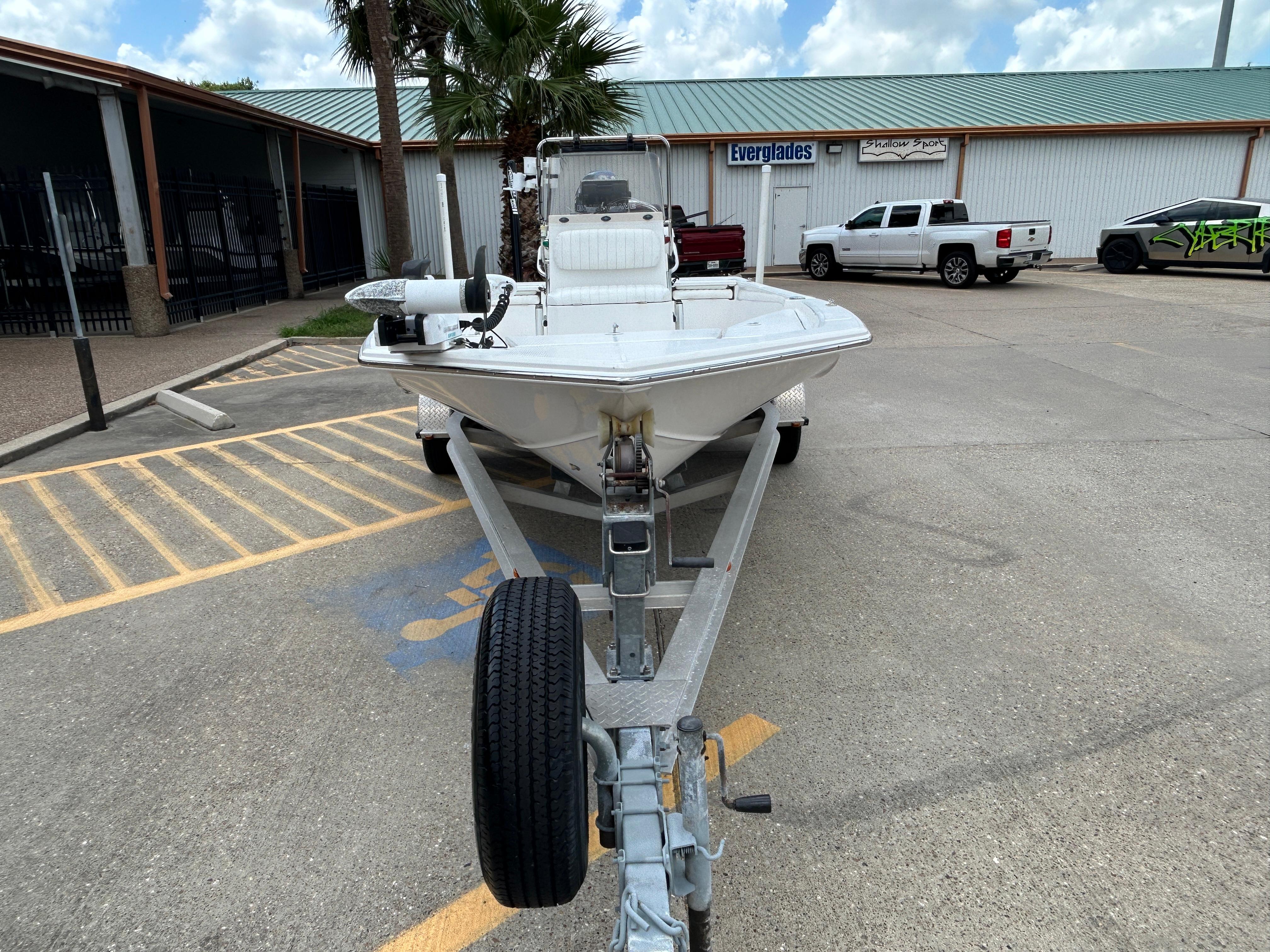 2012 Blue Wave 1900 STL boat on trailer in parking lot.