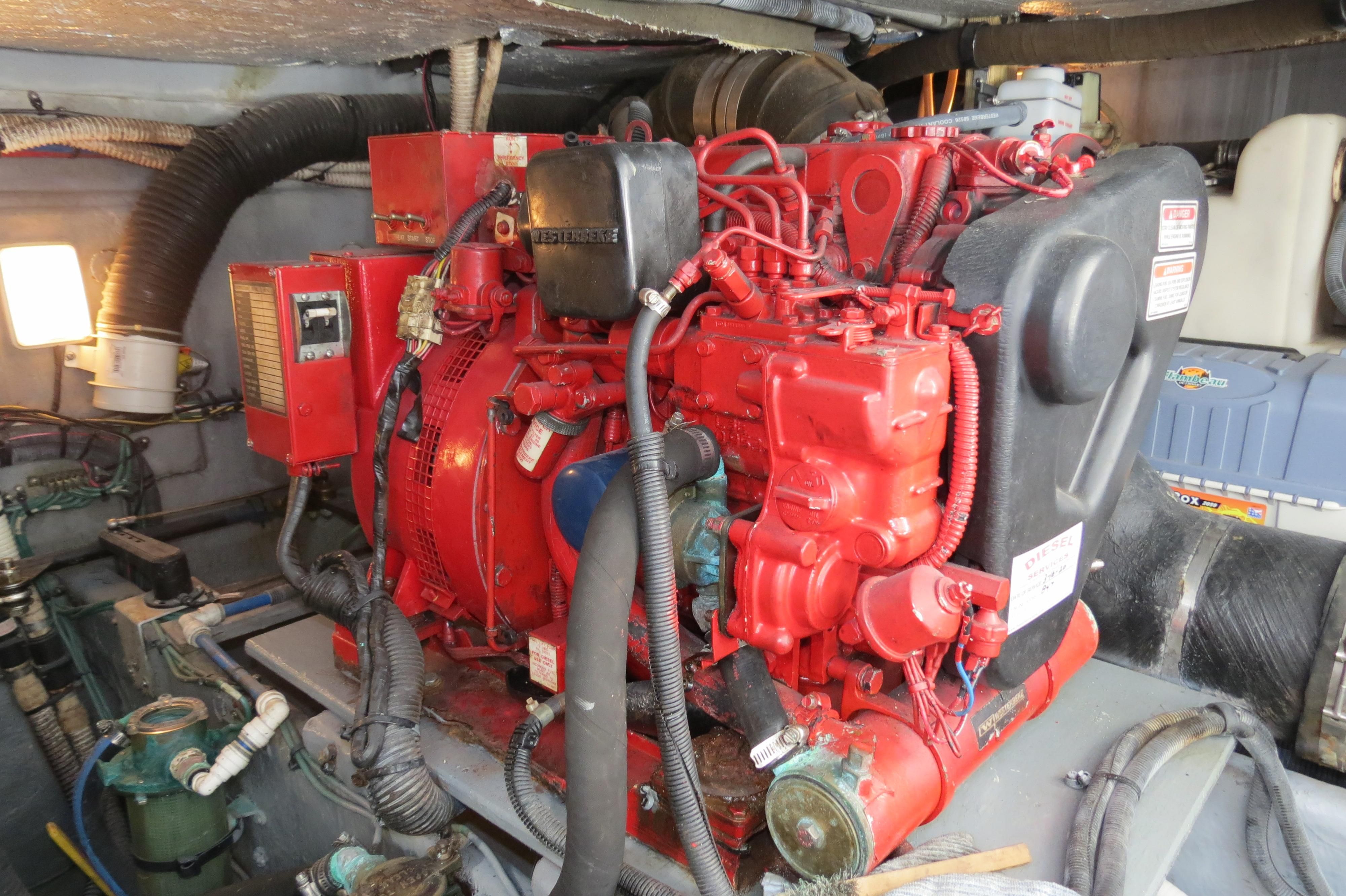 Engine room of a 2002 Sea Ray 410 Express Cruiser with a red engine.