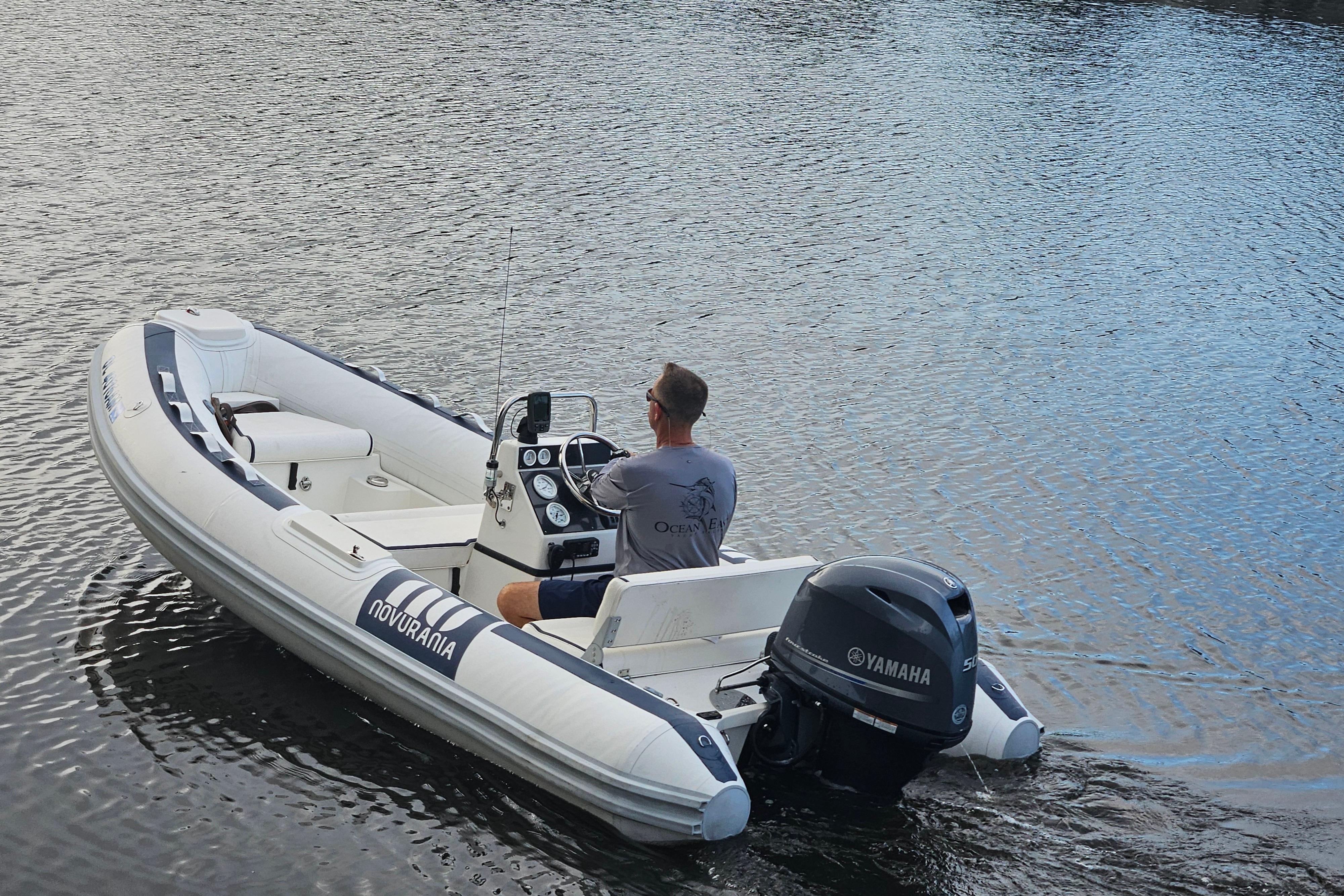 2019 Novurania DL 400 boat with Yamaha engine on calm water.