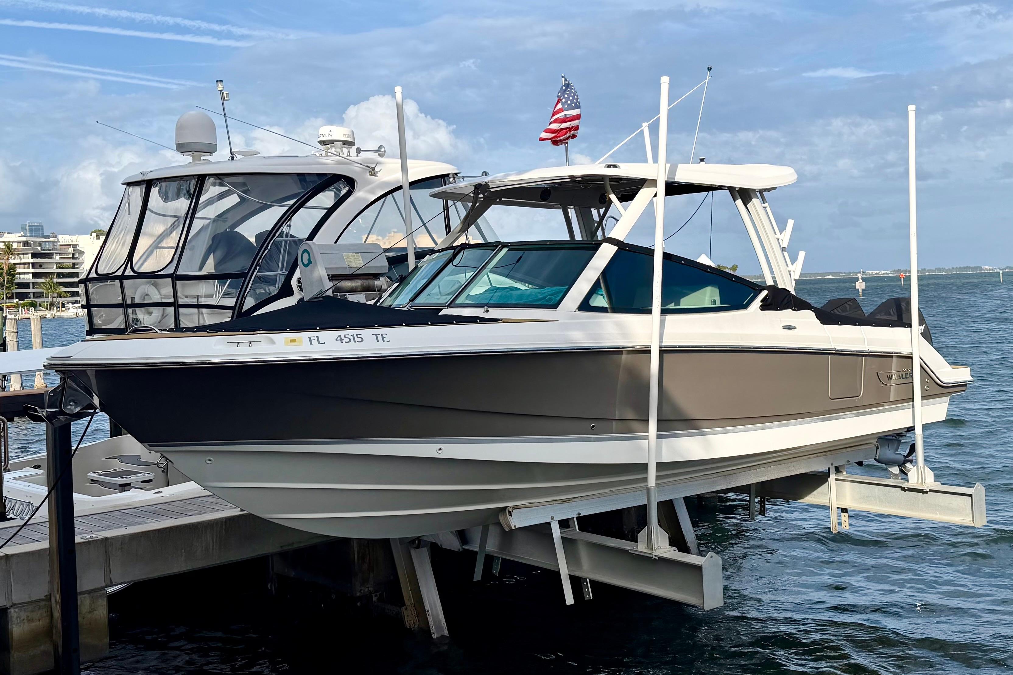 2022 Boston Whaler 280 Vantage boat docked, featuring sleek design and American flag.