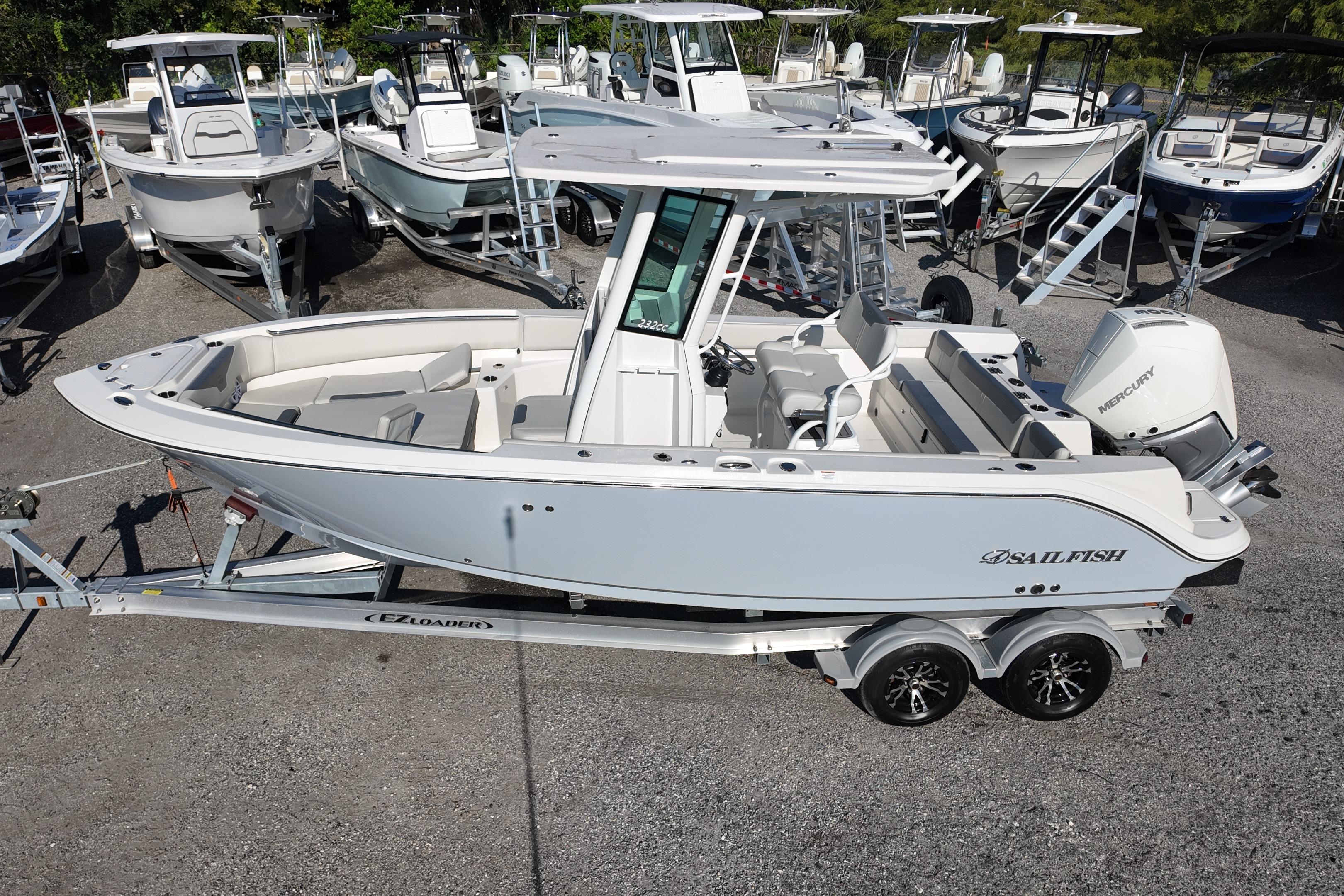 2026 Sailfish 232 CC boat on trailer, surrounded by other boats in a dealership.