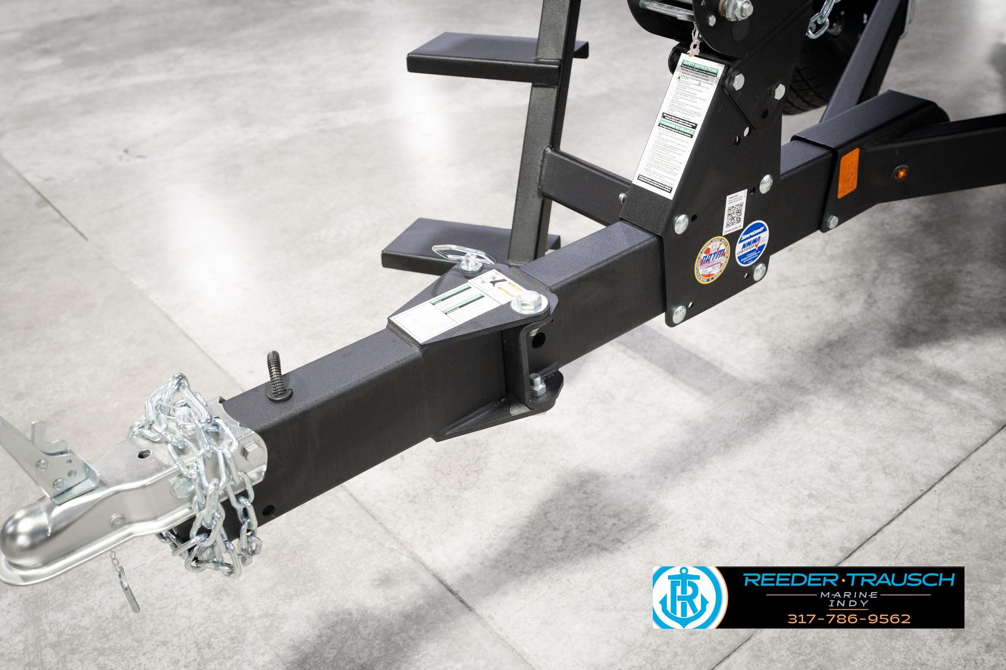Trailer hitch of 2026 Lund 1775 Impact XS SS boat, featuring safety chains and branding.