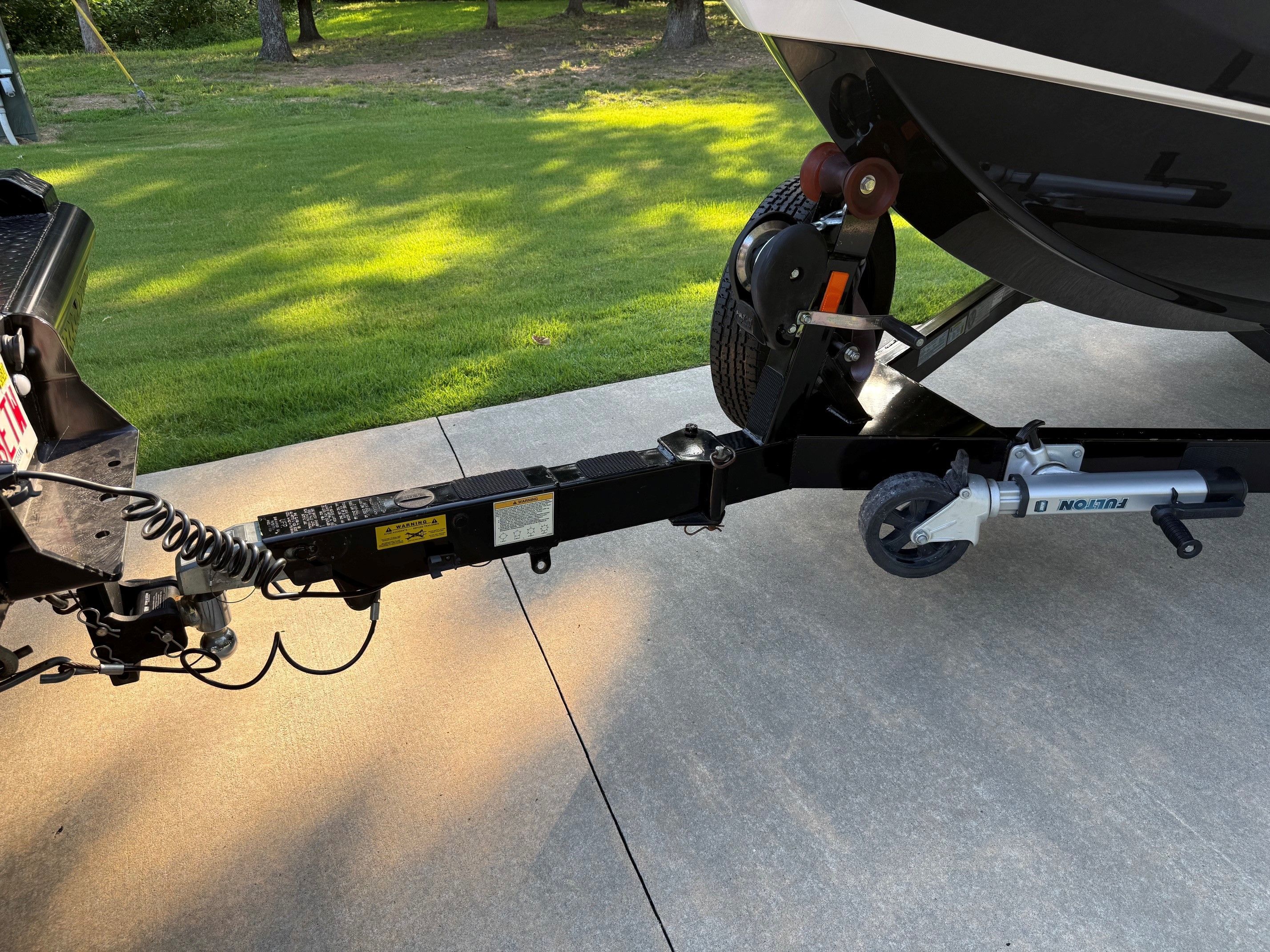Close-up of a boat trailer on a driveway.