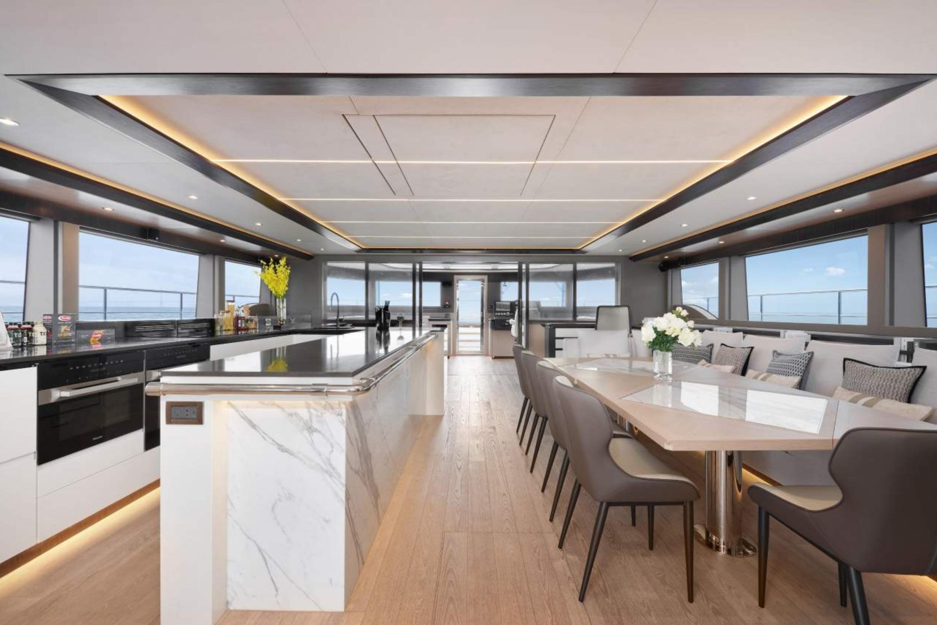 Luxurious interior of 2026 Heysea SV78 yacht with modern kitchen and elegant dining area.