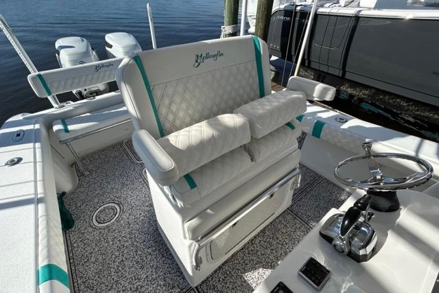 2002 Yellowfin 31 Center Console boat interior with cushioned seating and steering wheel.