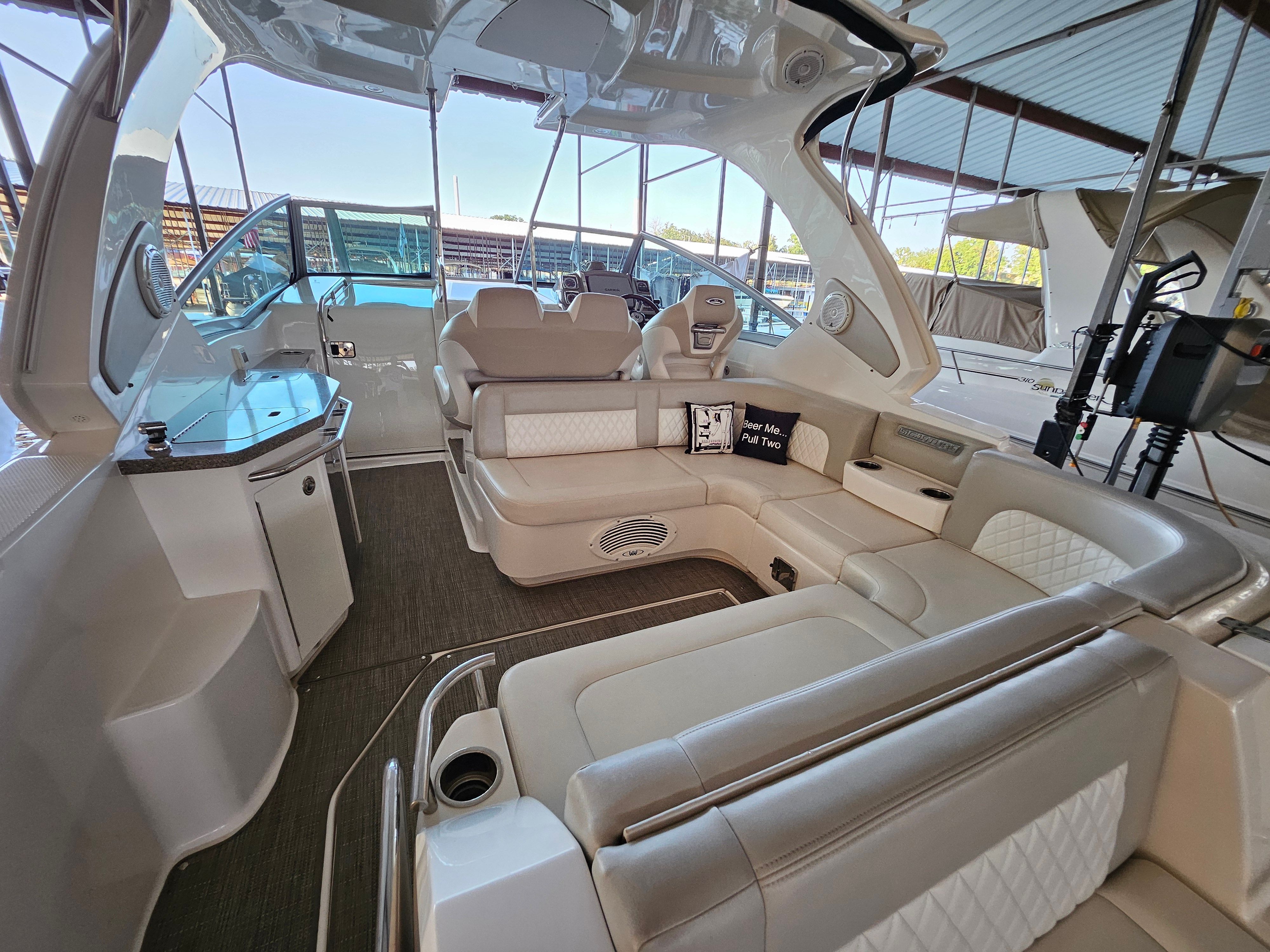 Interior of a 2014 Chaparral 330 Signature yacht with luxurious seating area.