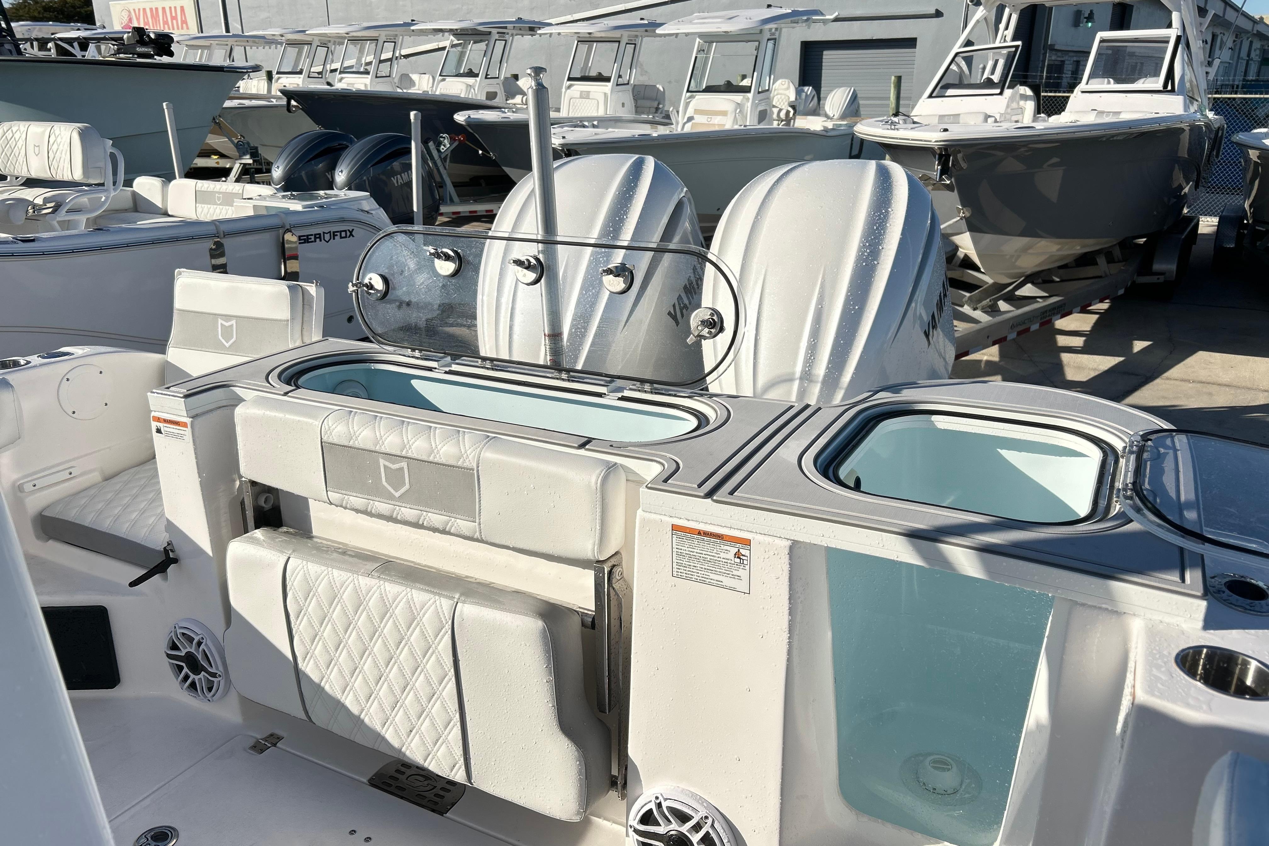2026 Sea Fox 288 Commander boat interior with dual Yamaha engines, docked among other boats.