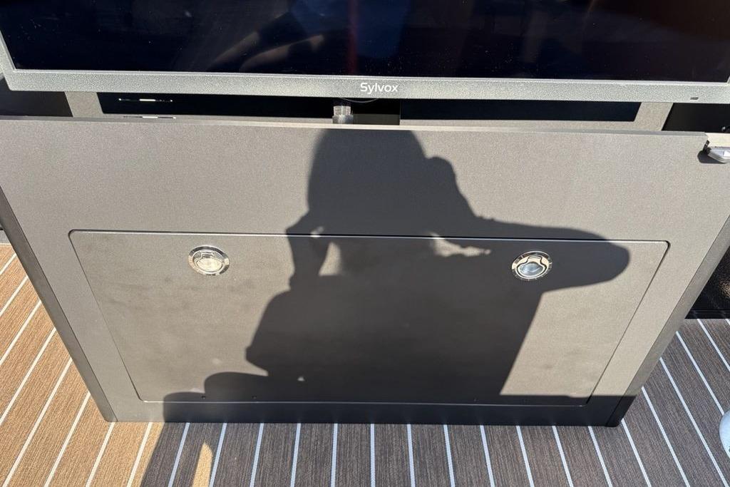 Shadow on a Premier 250 Solaris RS CL 2026 boat interior with striped flooring.