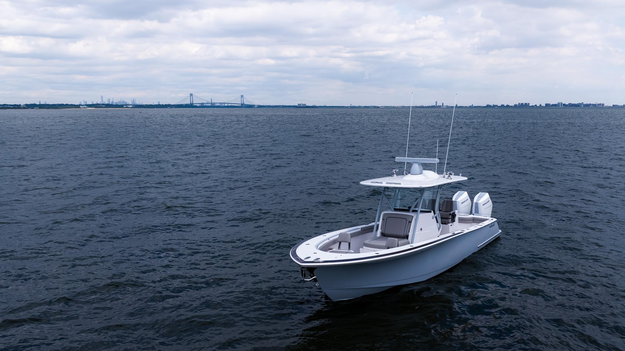 2025 Valhalla Boatworks V-33 on open water under cloudy sky.
