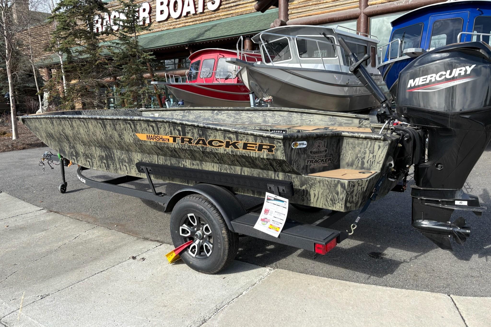 2026 Tracker Grizzly 1756 T Marsh boat with Mercury engine displayed outdoors.