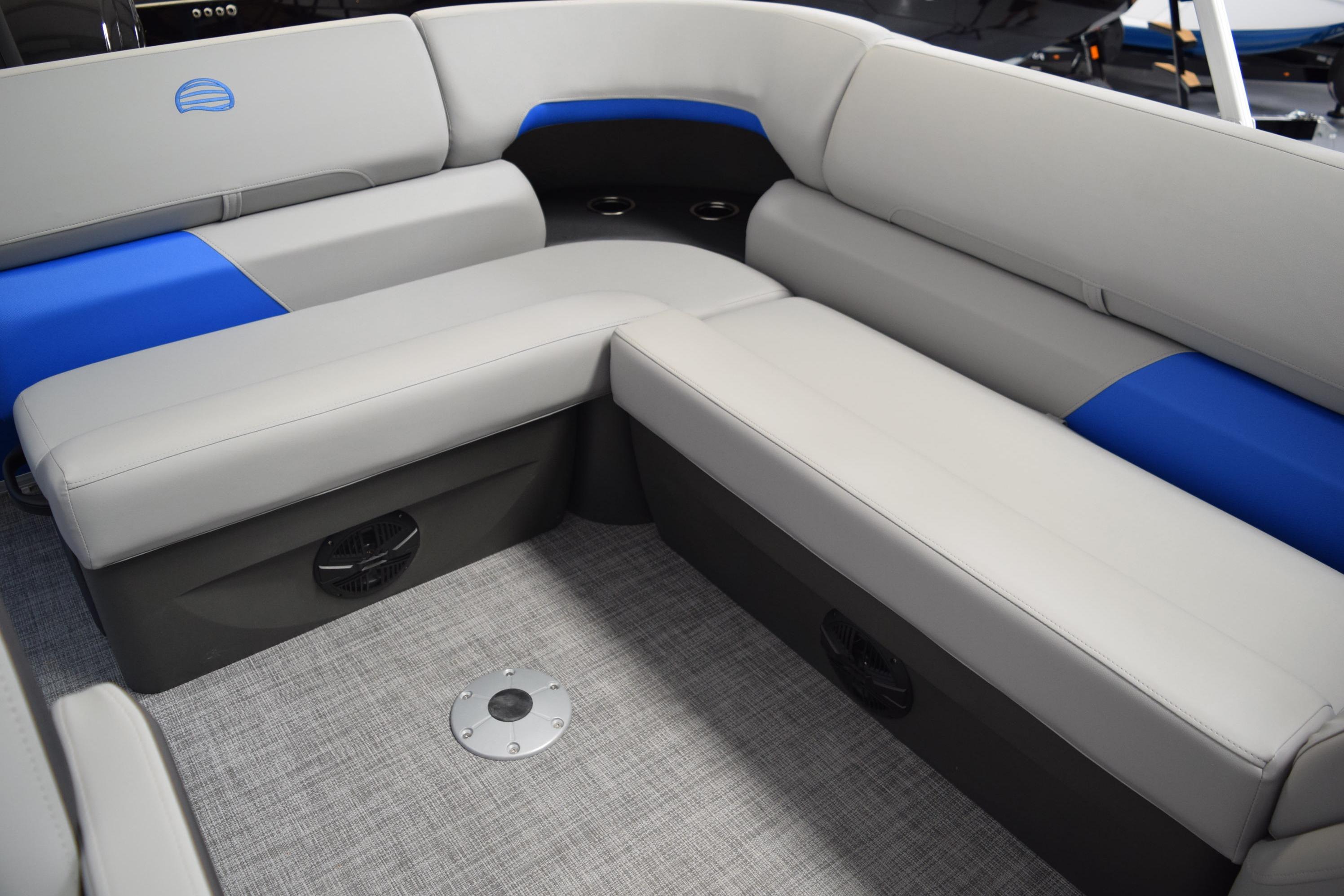 2026 Sun Tracker Party Barge 20 DLX interior seating with gray and blue upholstery.
