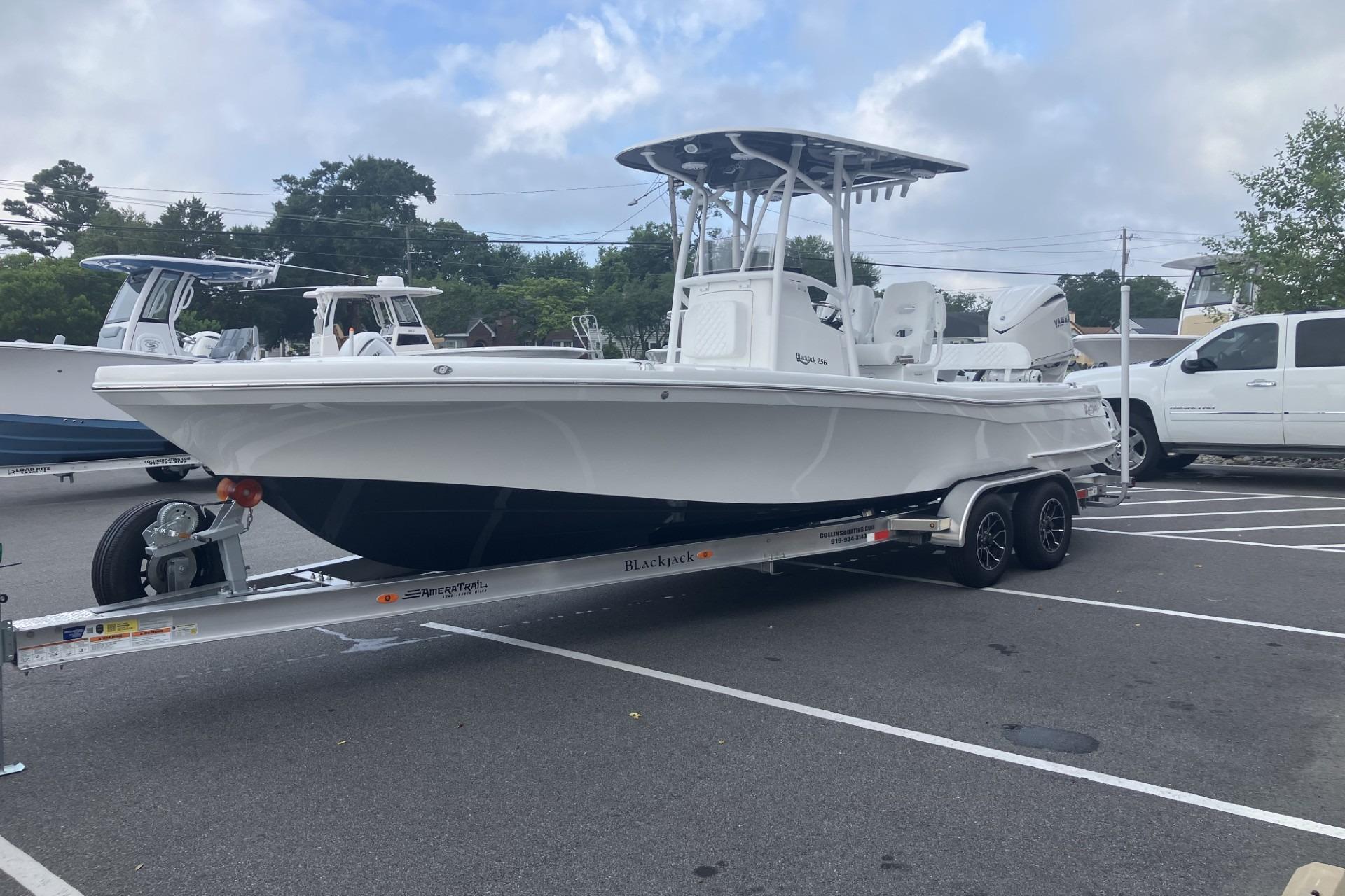 2026 BlackJack 256 Coastal boat on trailer in parking lot, ready for transport.