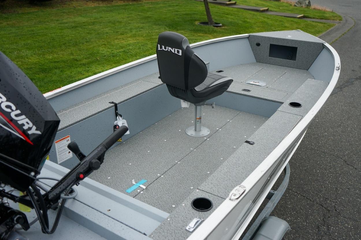 2026 Lund 1400 Fury Tiller boat with Mercury engine, featuring spacious interior and single seat.