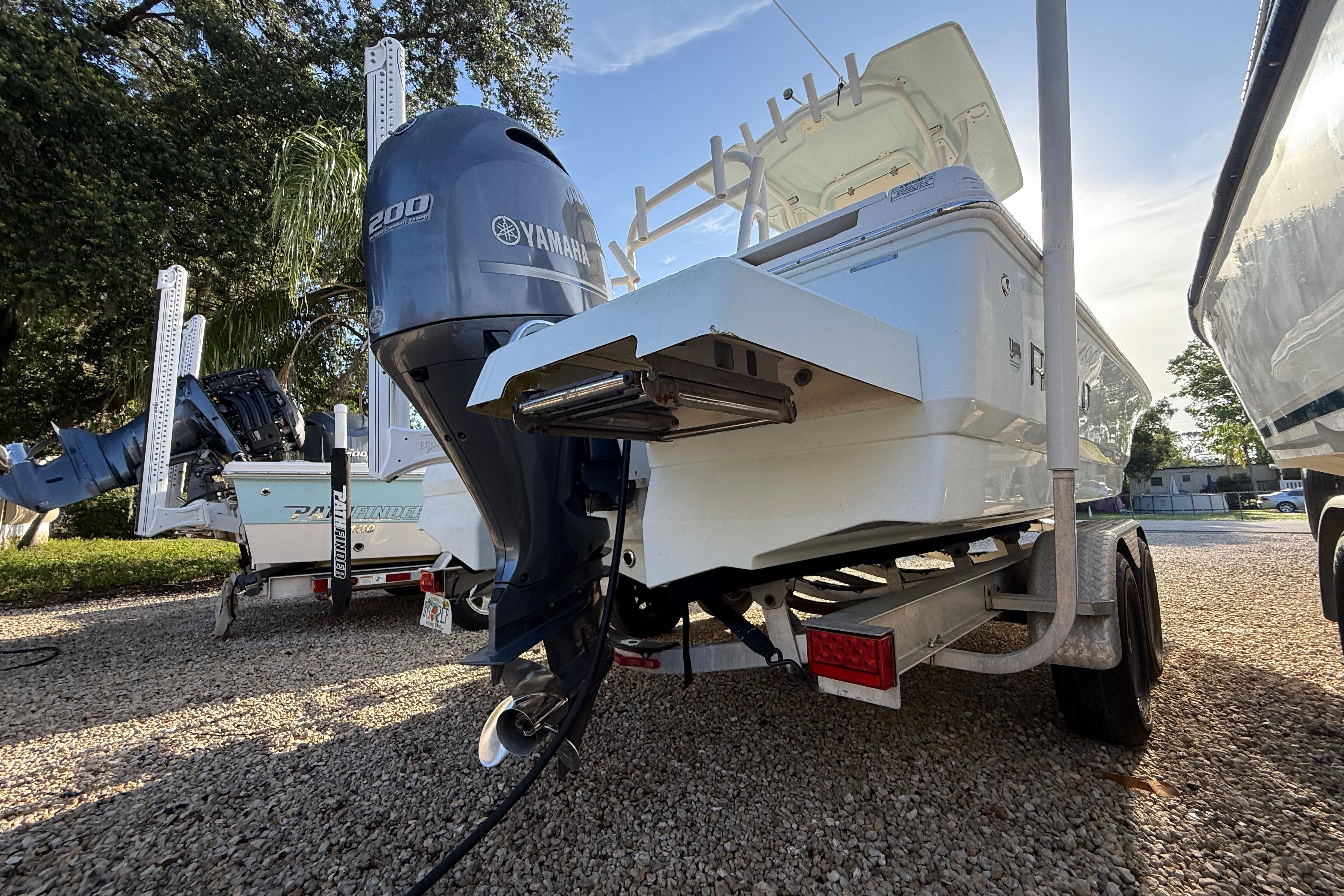 2017 Robalo 226 Cayman boat with Yamaha 200 engine on trailer, parked outdoors.