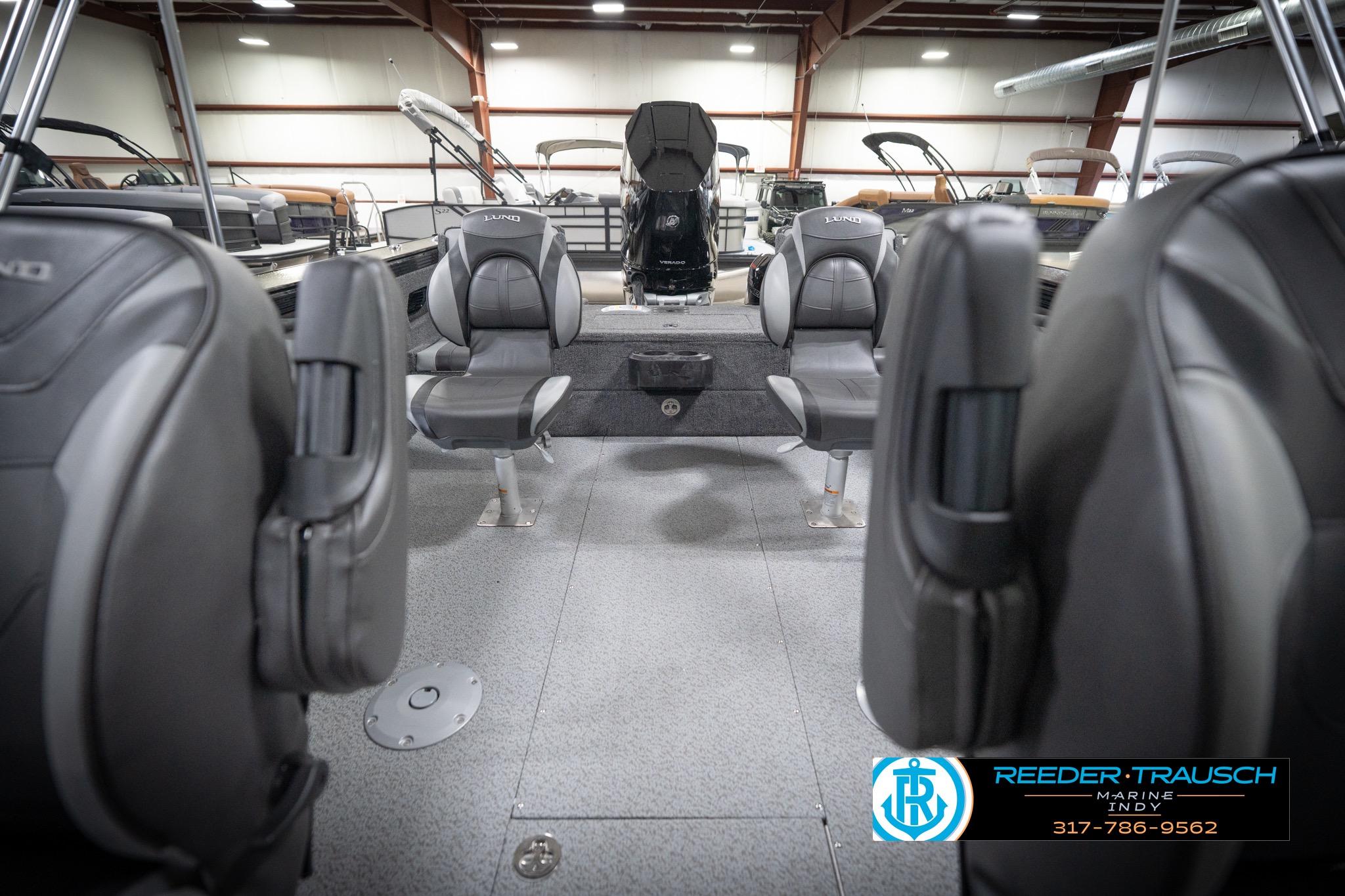 2026 Lund 2275 Baron boat interior with gray seating in a showroom.