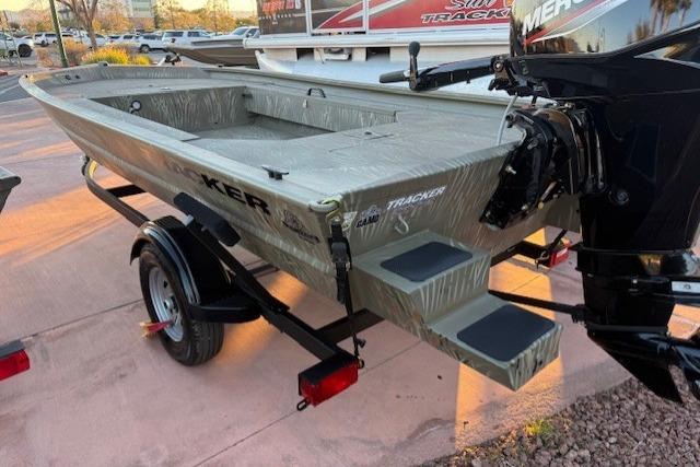 2025 Tracker Grizzly 1654 T Sportsman boat on trailer, rear view with motor.