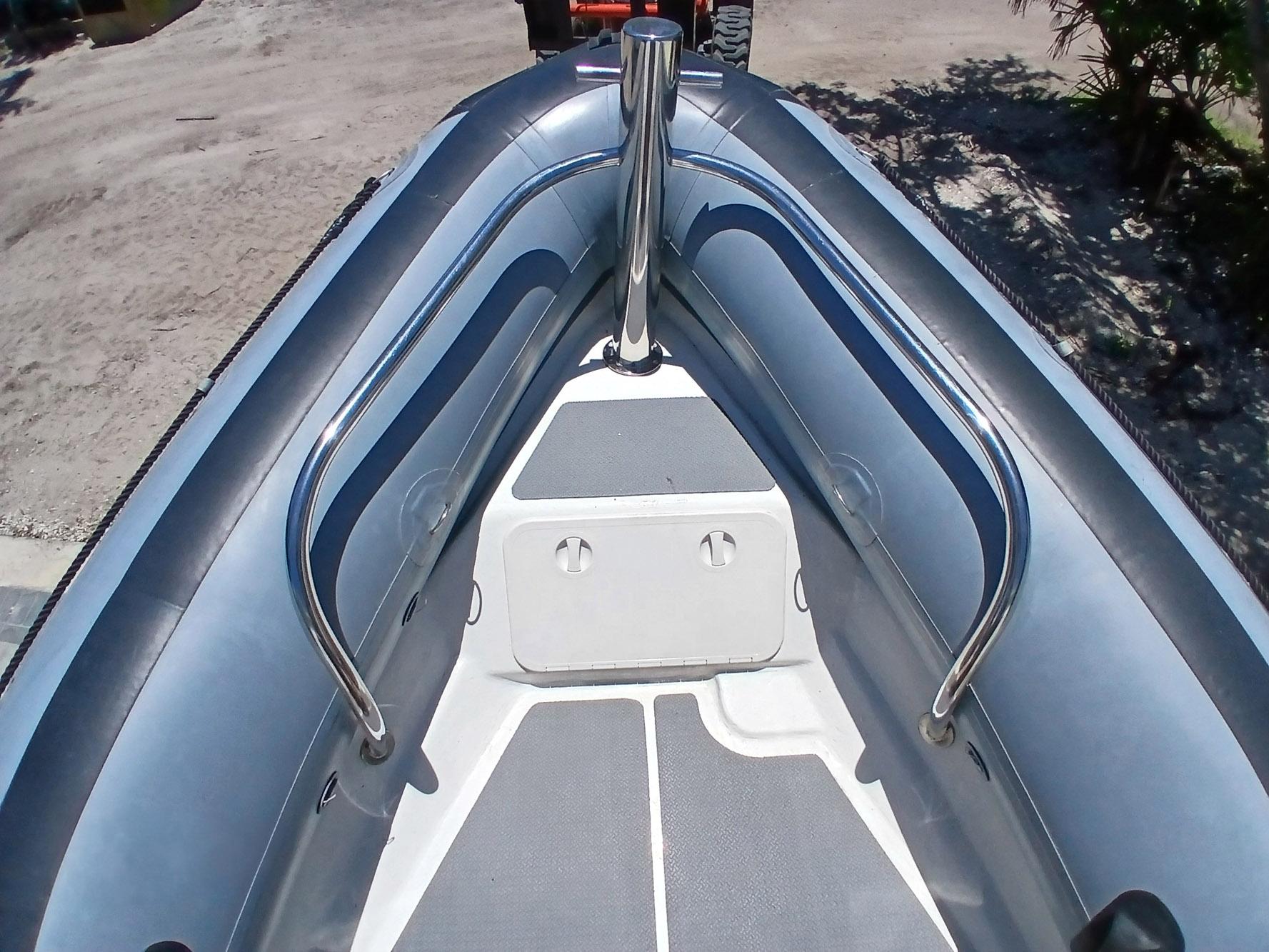 2002 Protector 28 Targa boat interior with stainless steel railings and non-slip flooring.