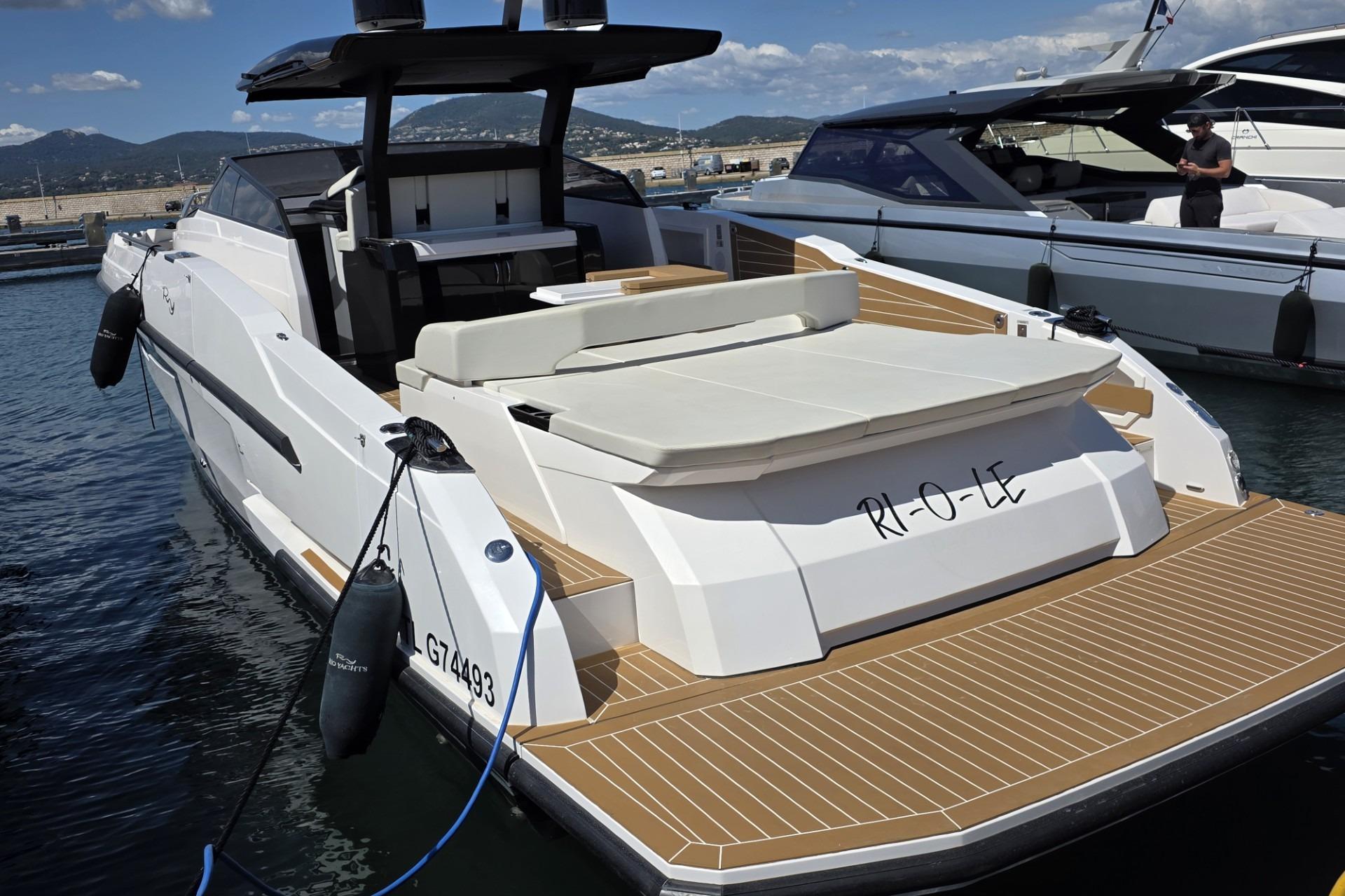 2024 Rio Yachts Daytona 50 luxury yacht docked at marina, showcasing sleek design and spacious deck.