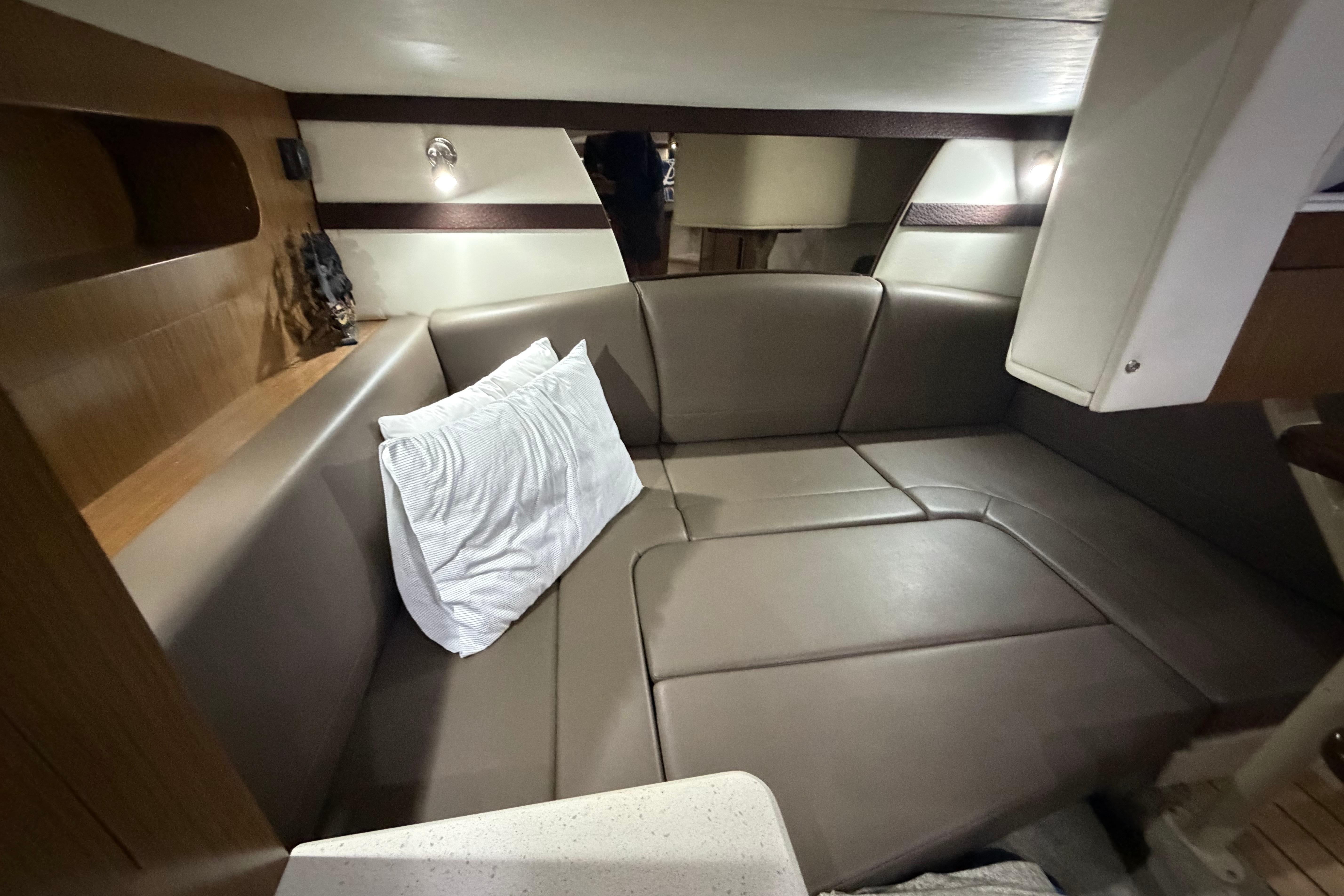 2014 Cruisers 350 Express cabin interior with leather seating and ambient lighting.