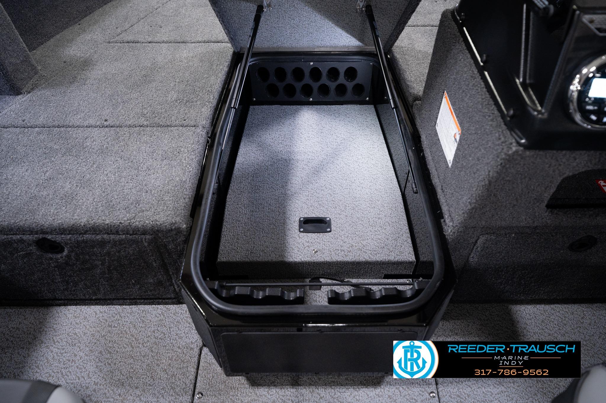 2026 Lund 1775 Impact XS SS boat interior storage compartment, featuring carpeted finish and organized layout.