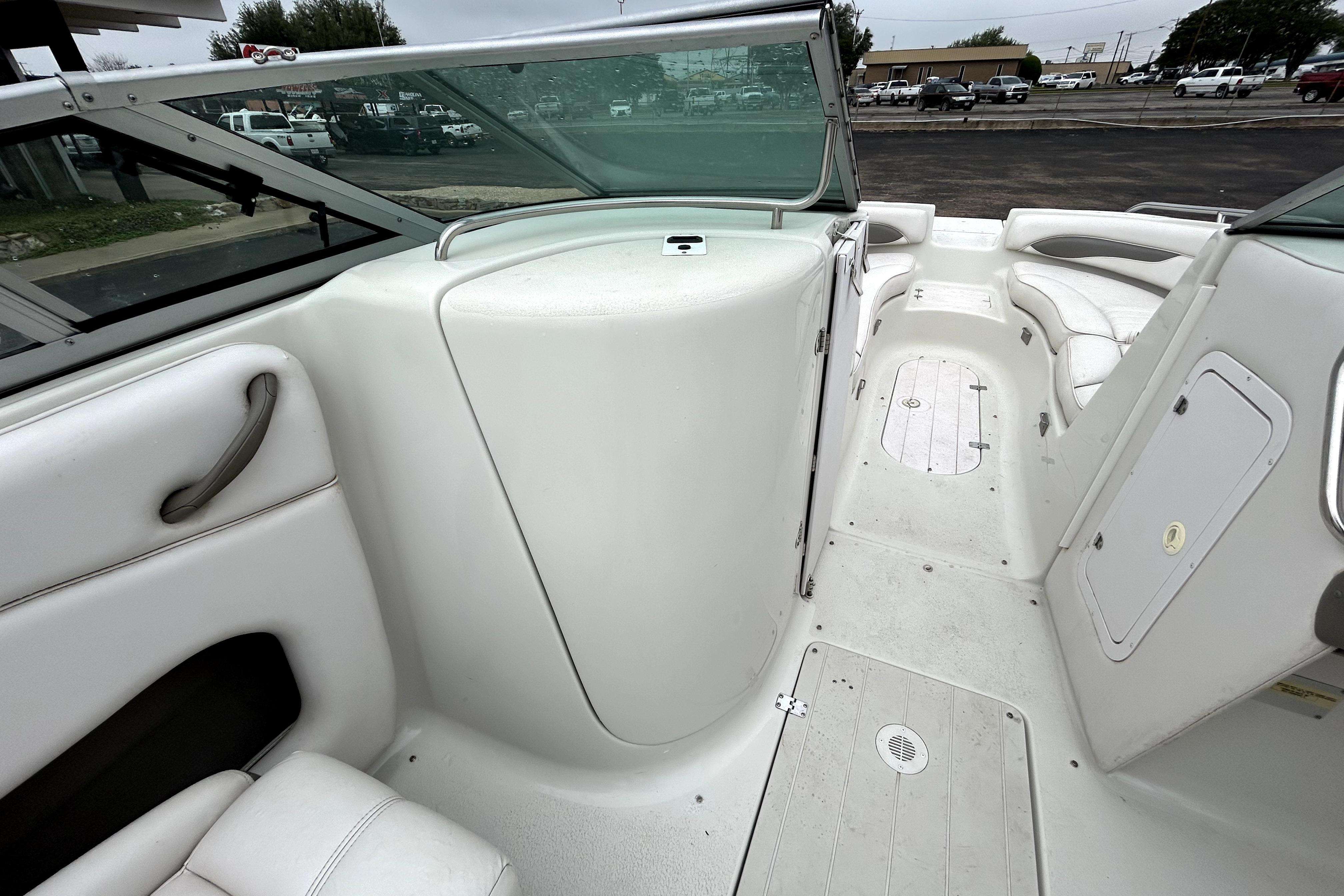 2001 Crownline 239 DB boat interior with white seating and storage compartments.