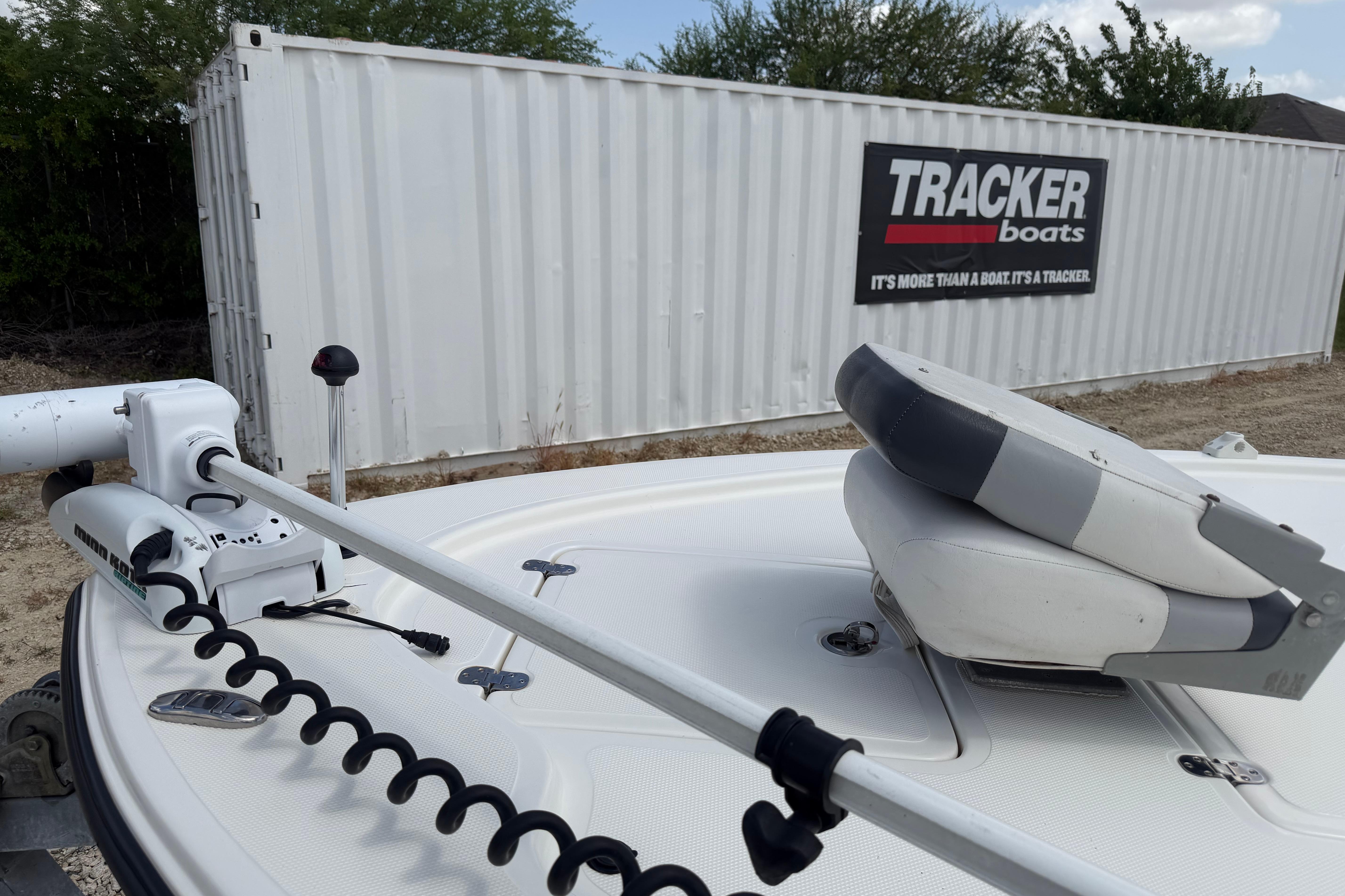 2012 Mako 18 LTS boat with trolling motor, near Tracker Boats container.