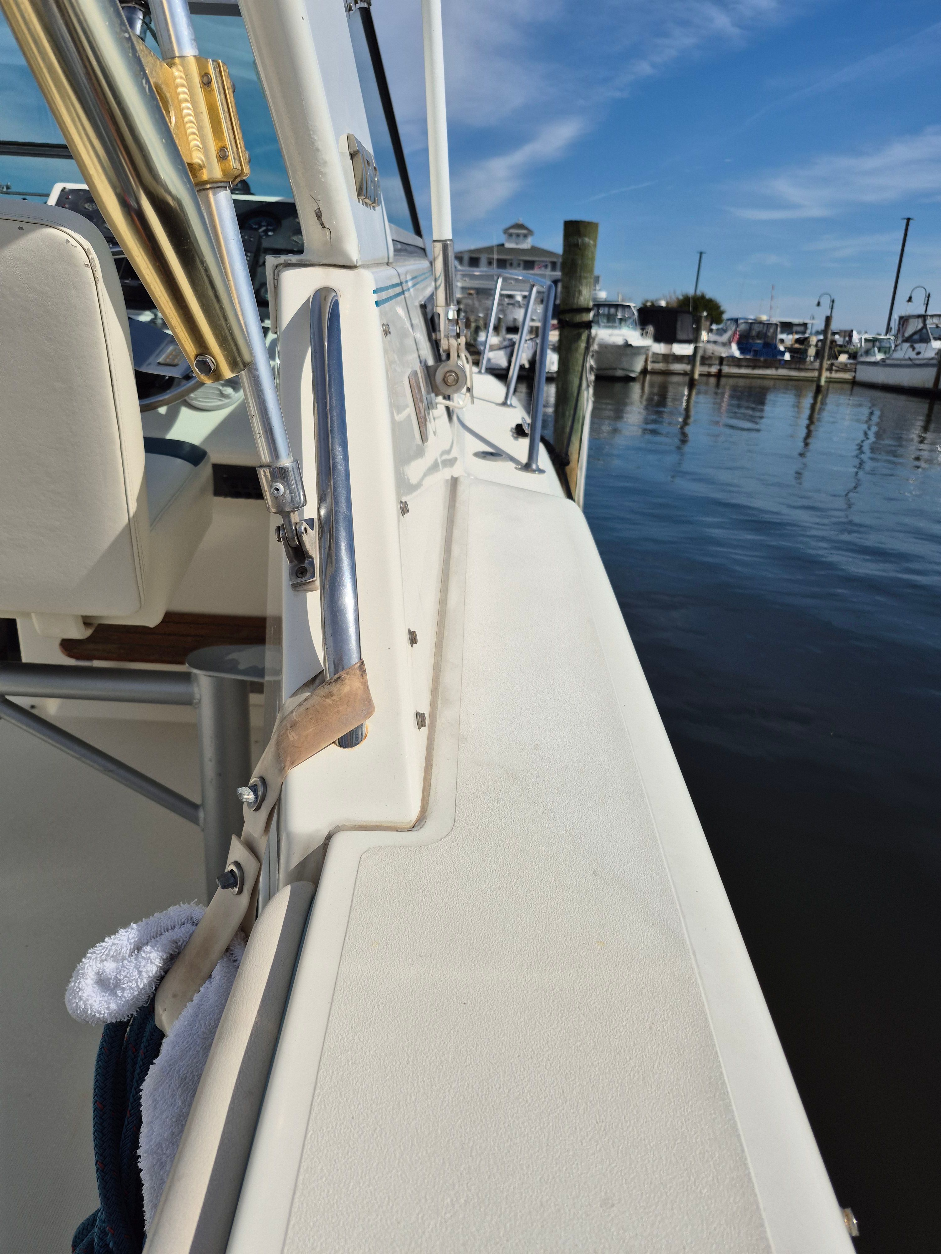 A 1989 Tiara Yachts Slickcraft docked with a blue sky in the background.