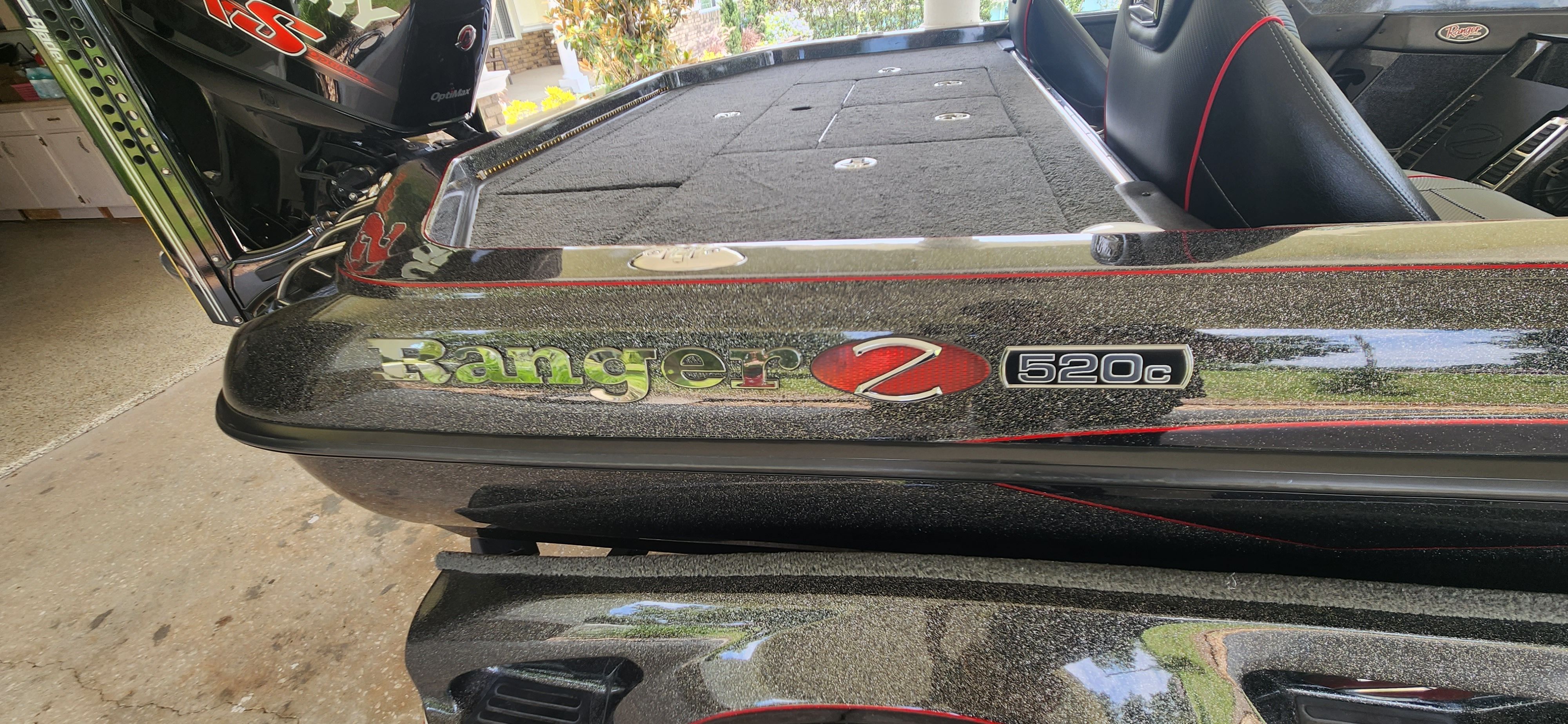 Close-up of a Ranger Z520 Comanche boat with black and red design.