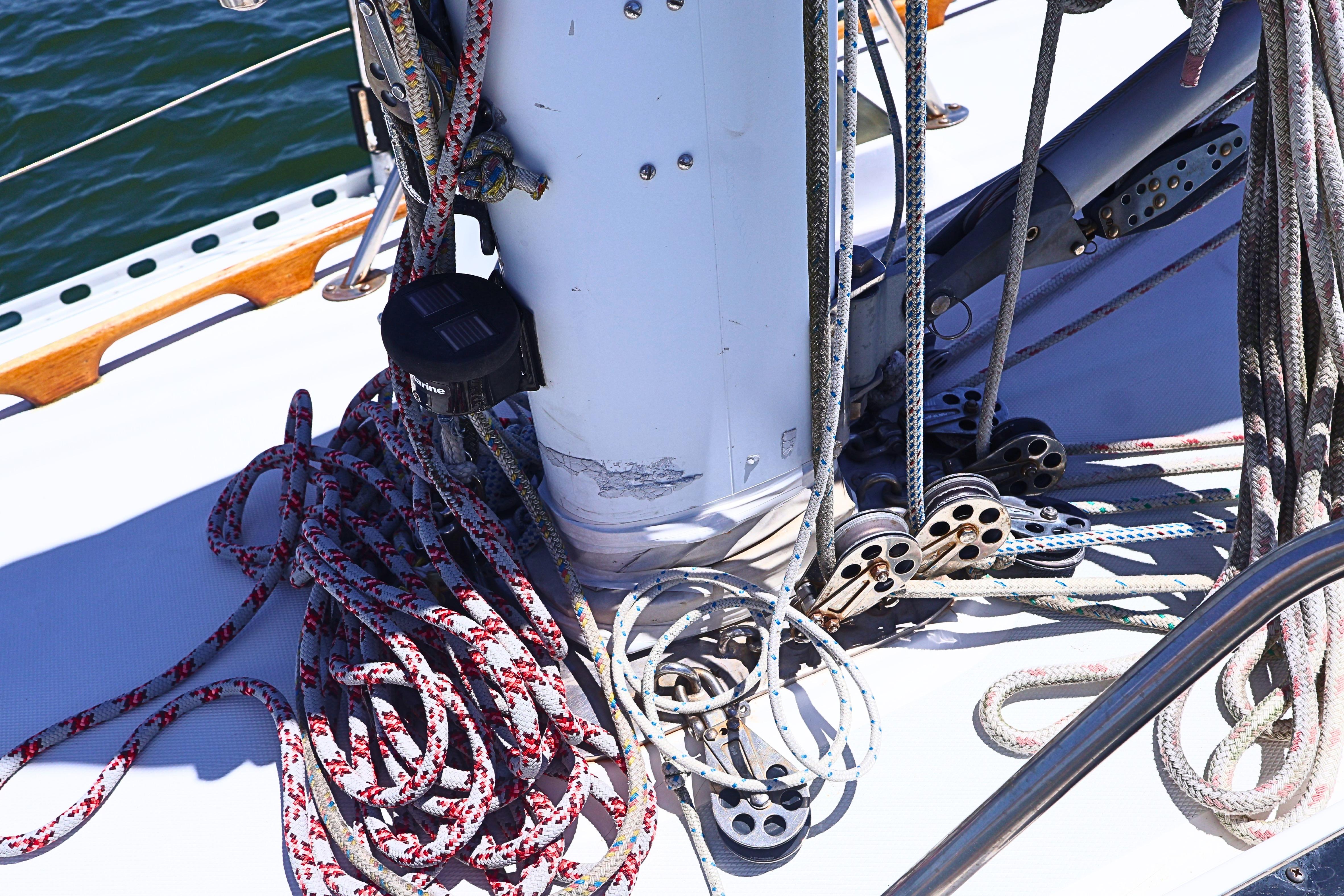 Deck of 1989 J Boat J 40 with ropes and pulleys in sunlight.