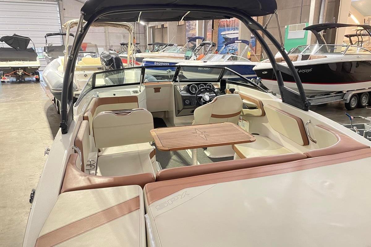 Interior view of a 2017 Sea Ray SPX 210 boat in showroom.