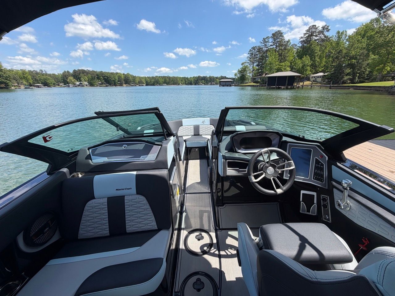 Interior of a 2023 MasterCraft X24 boat on a lake.