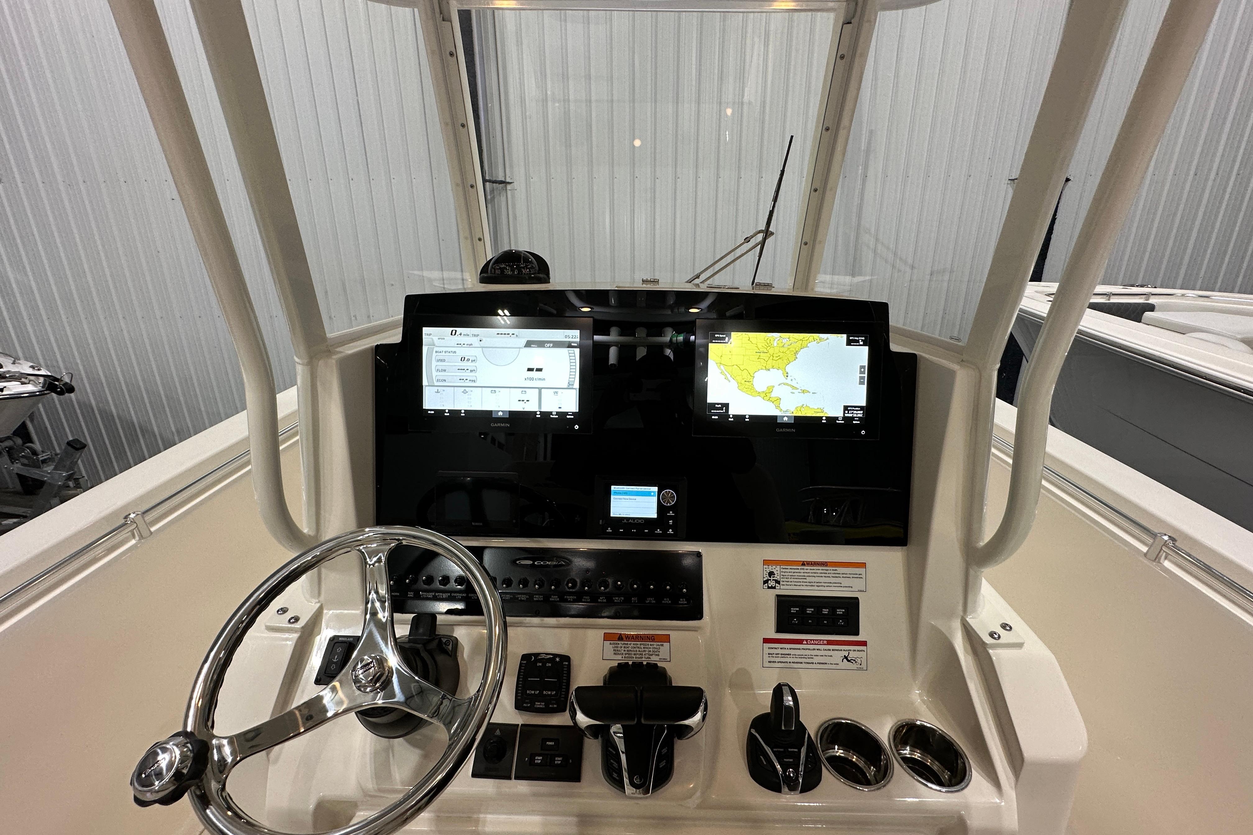 2024 Cobia 301 Center Console helm with navigation screens and controls.