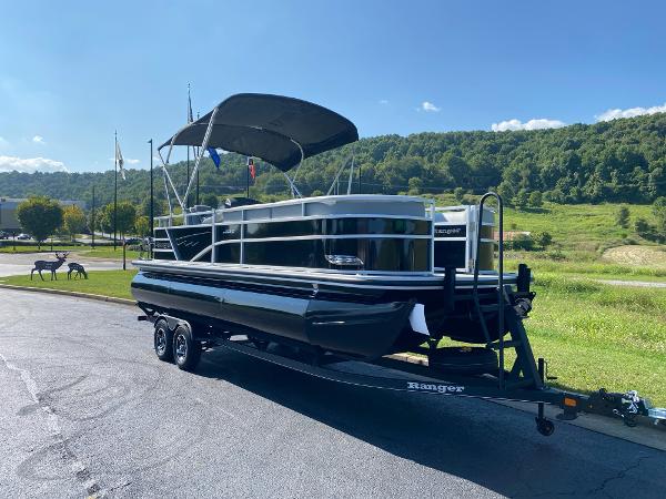 2024 Ranger Reata 223C pontoon boat on trailer, parked in scenic outdoor setting.