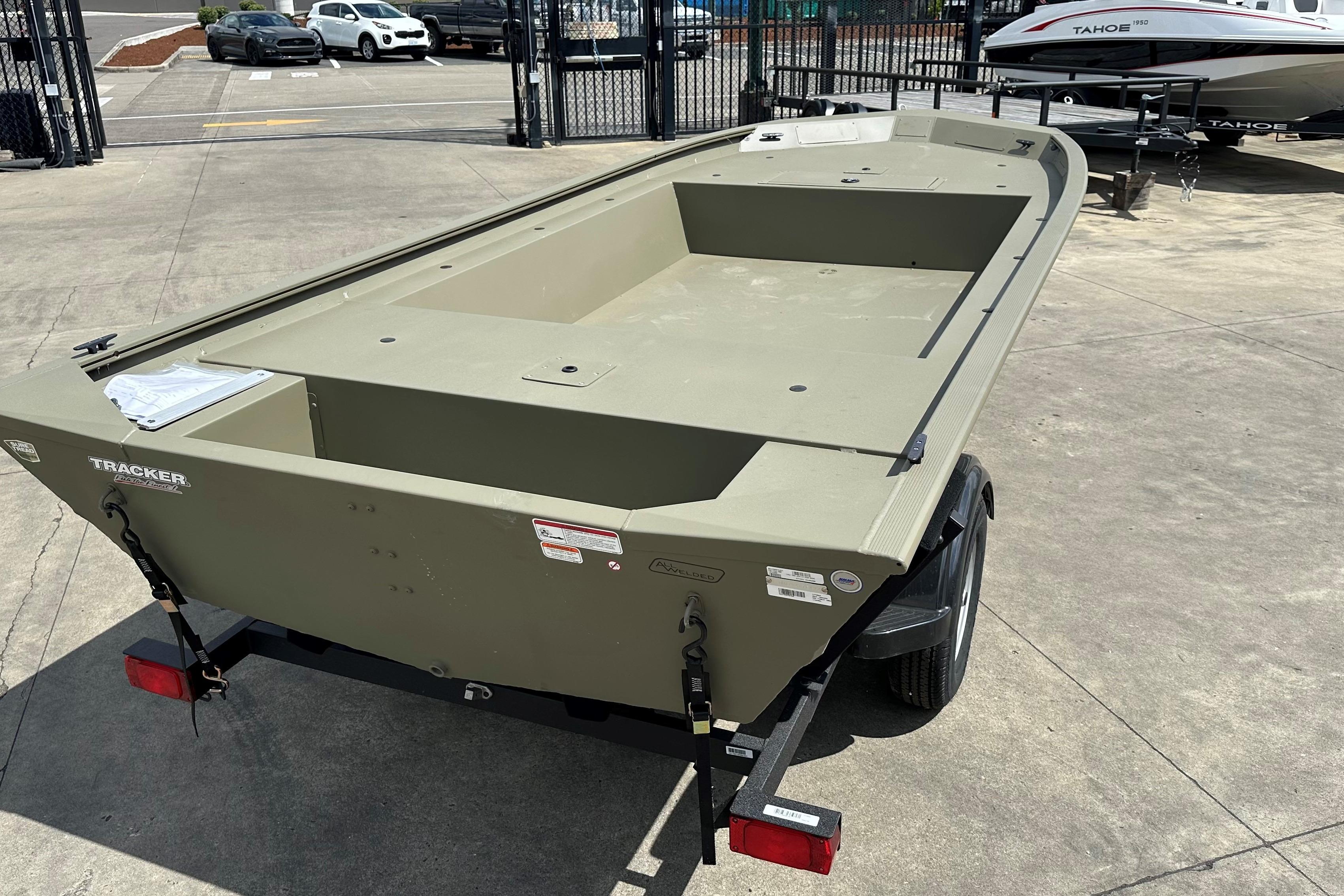 2026 Tracker Grizzly 1754 Utility boat on trailer in outdoor lot.