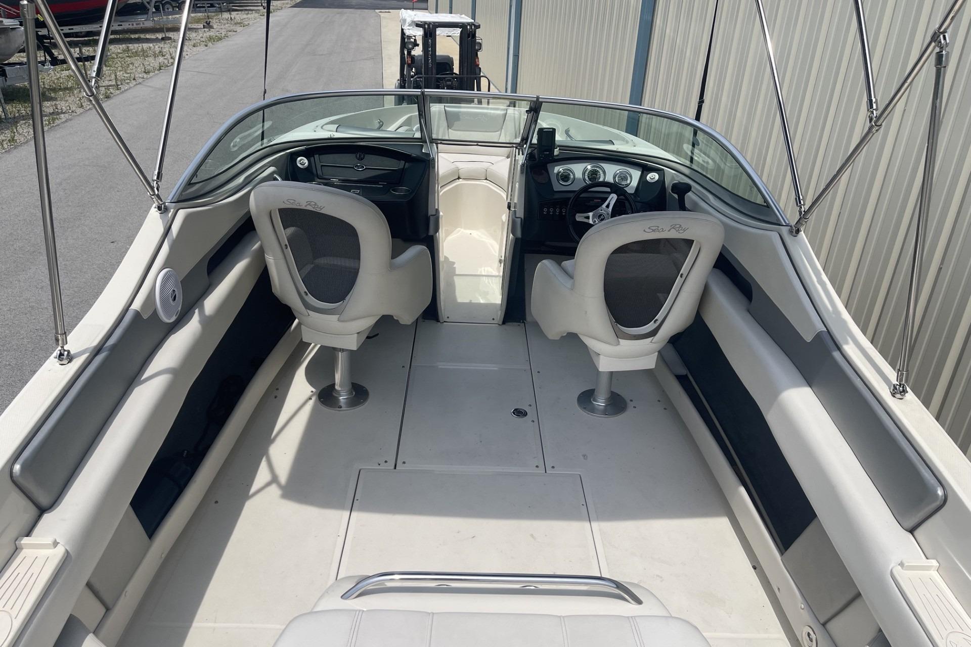 2010 Sea Ray 230 Bow Rider Select interior with dual captain chairs and dashboard view.