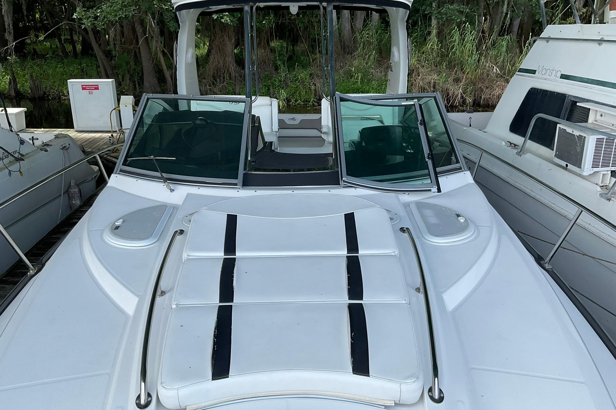 2019 Monterey 335 Sport Yacht docked, featuring sleek design and spacious deck.