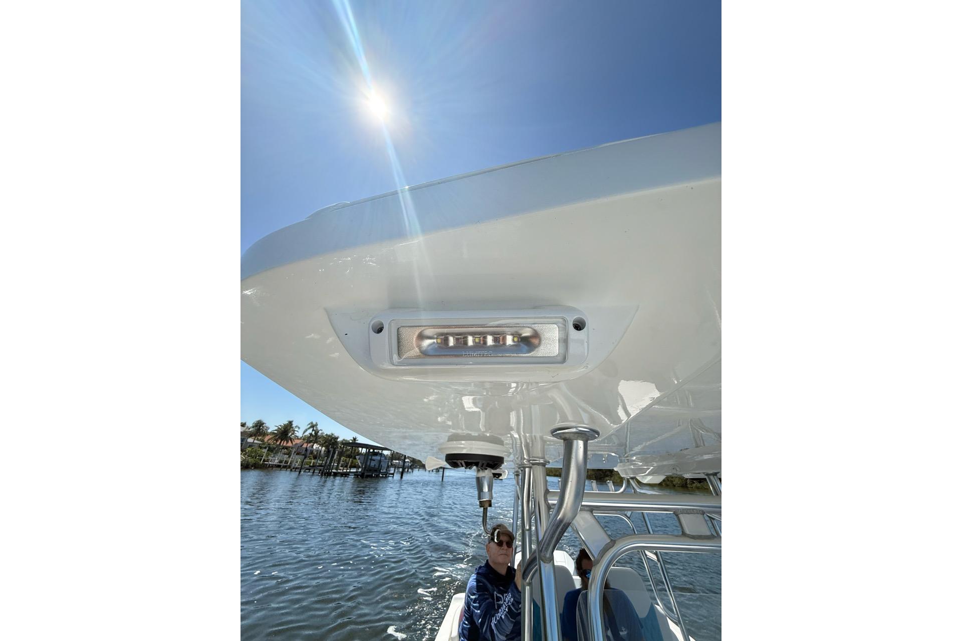 2021 Custom Infusion 34 CC boat under sunny sky, featuring sleek design and modern lighting.