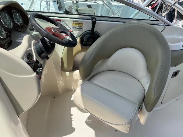 2005 Sea Ray 220 Sundeck helm with steering wheel and comfortable captain's chair.