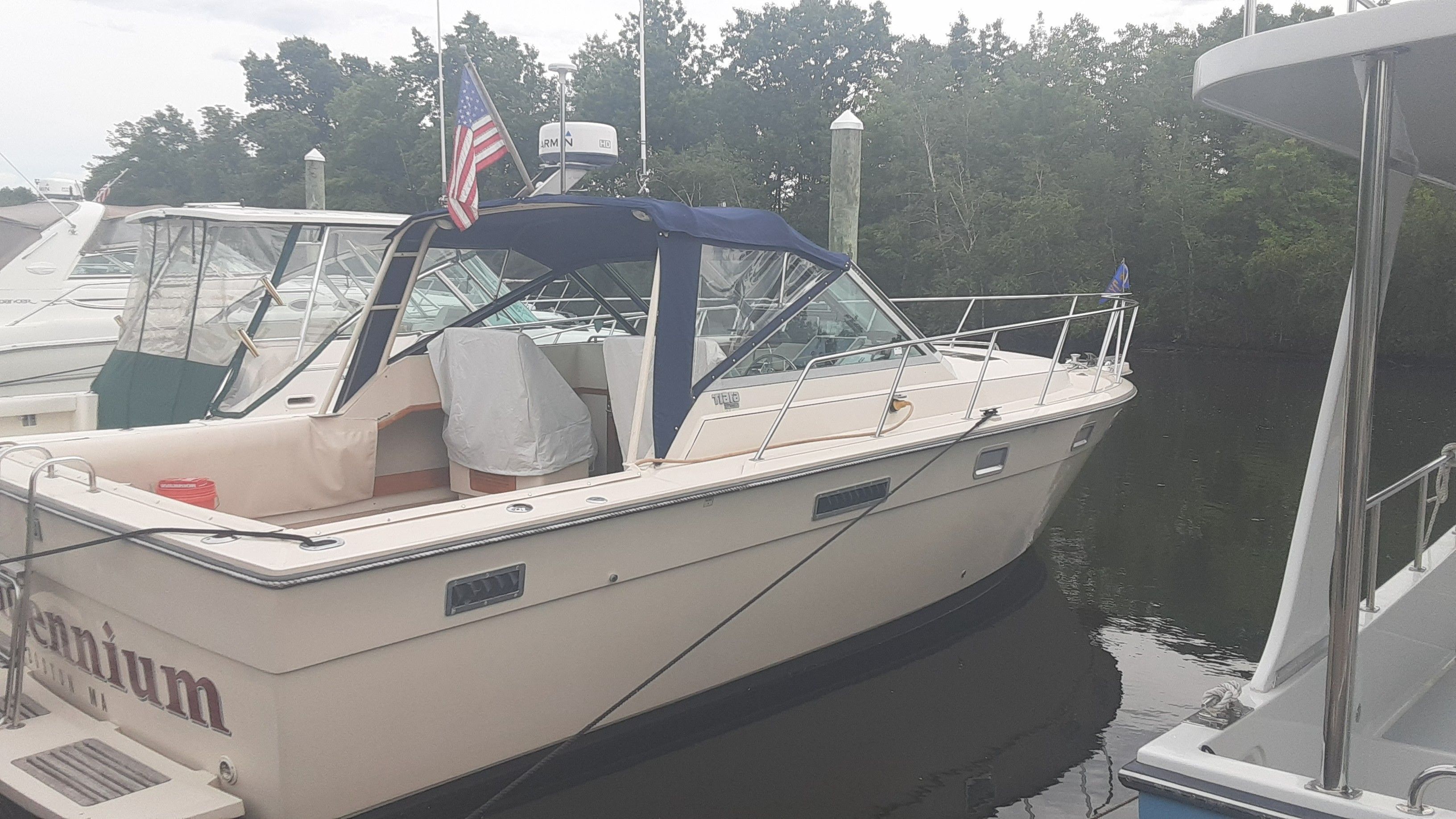 1985 Tiara Yachts 3100 Open docked, featuring American flag.