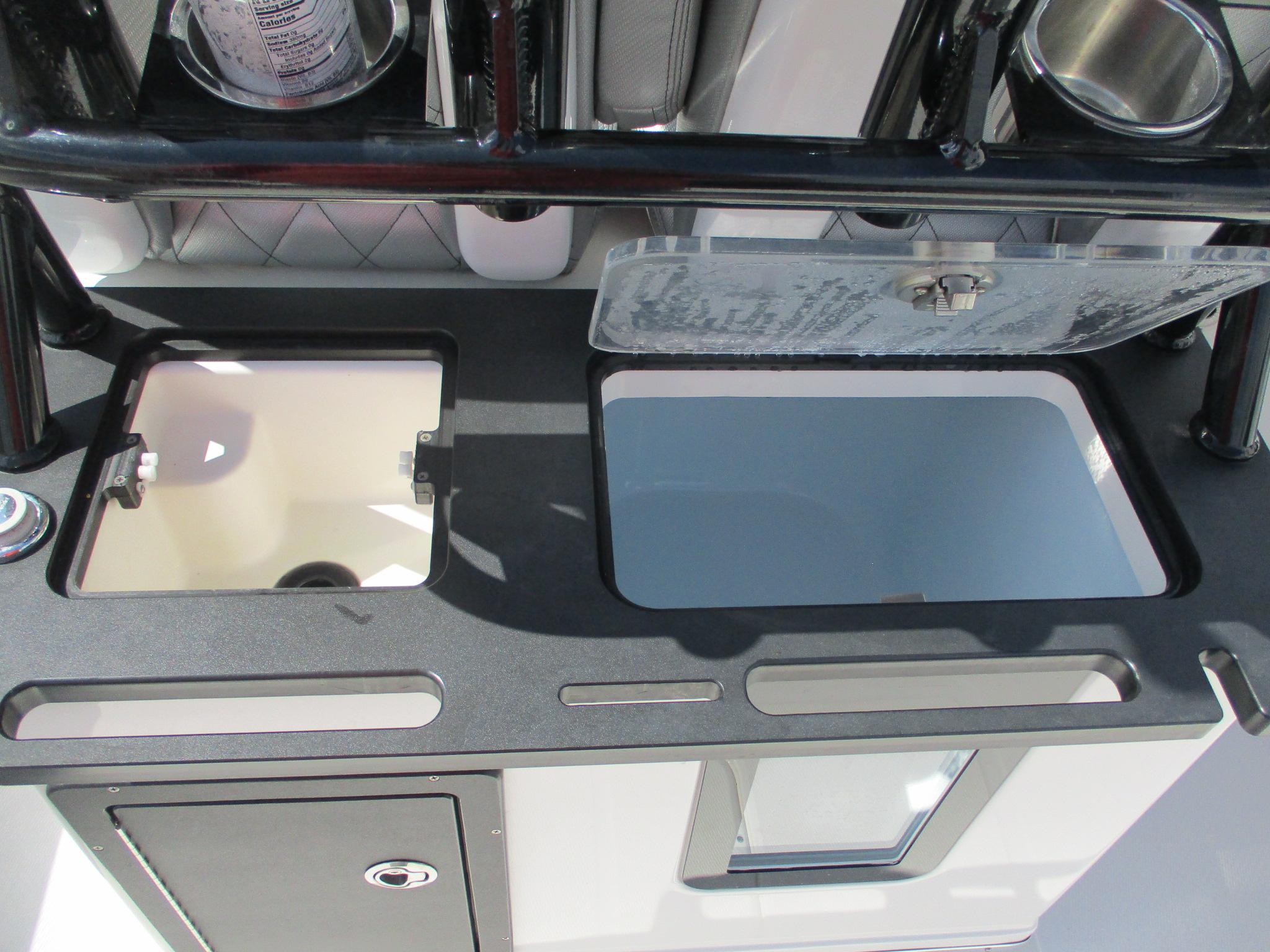2024 Blue Wave 2800 Makaira boat interior with storage compartments and cup holders.