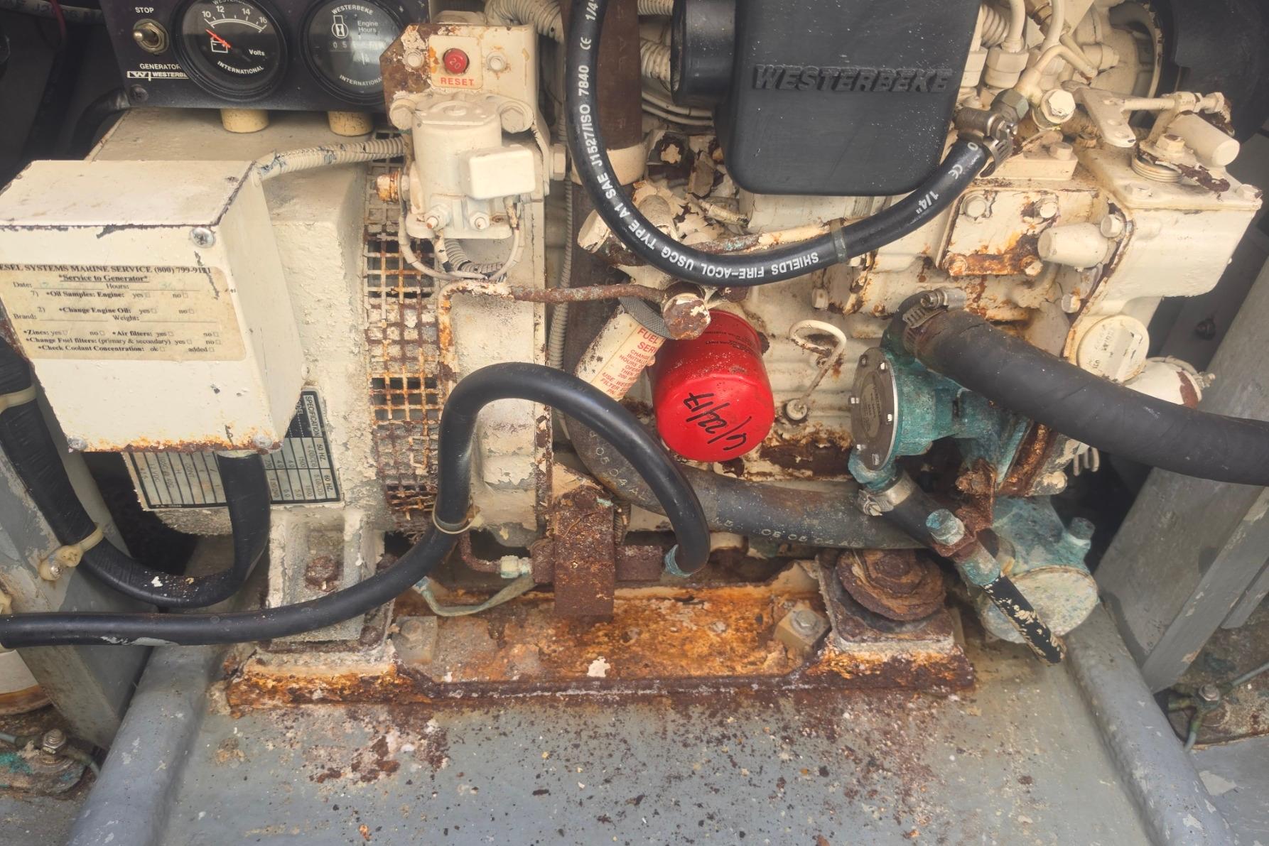Engine compartment of a 1999 Albemarle 305 Express Fisherman, showing rust and wear.