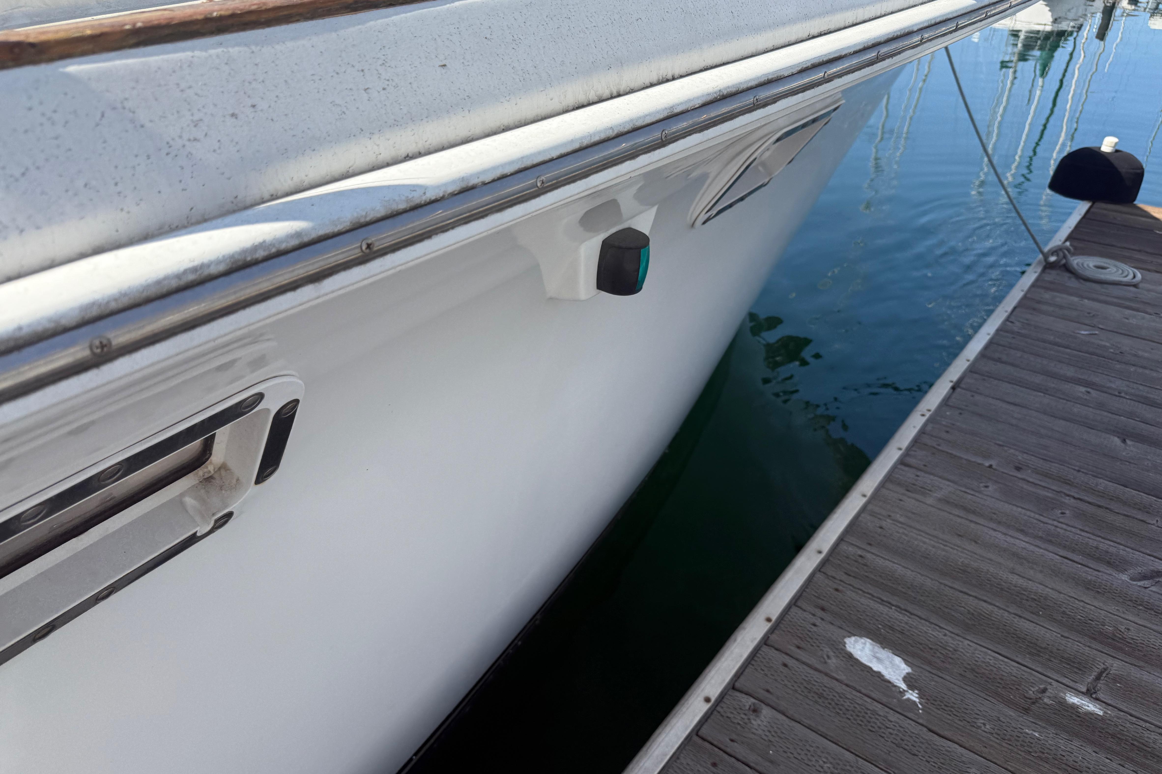 1974 Pacemaker 48 Sportfisherman docked, showcasing sleek white hull and marina setting.