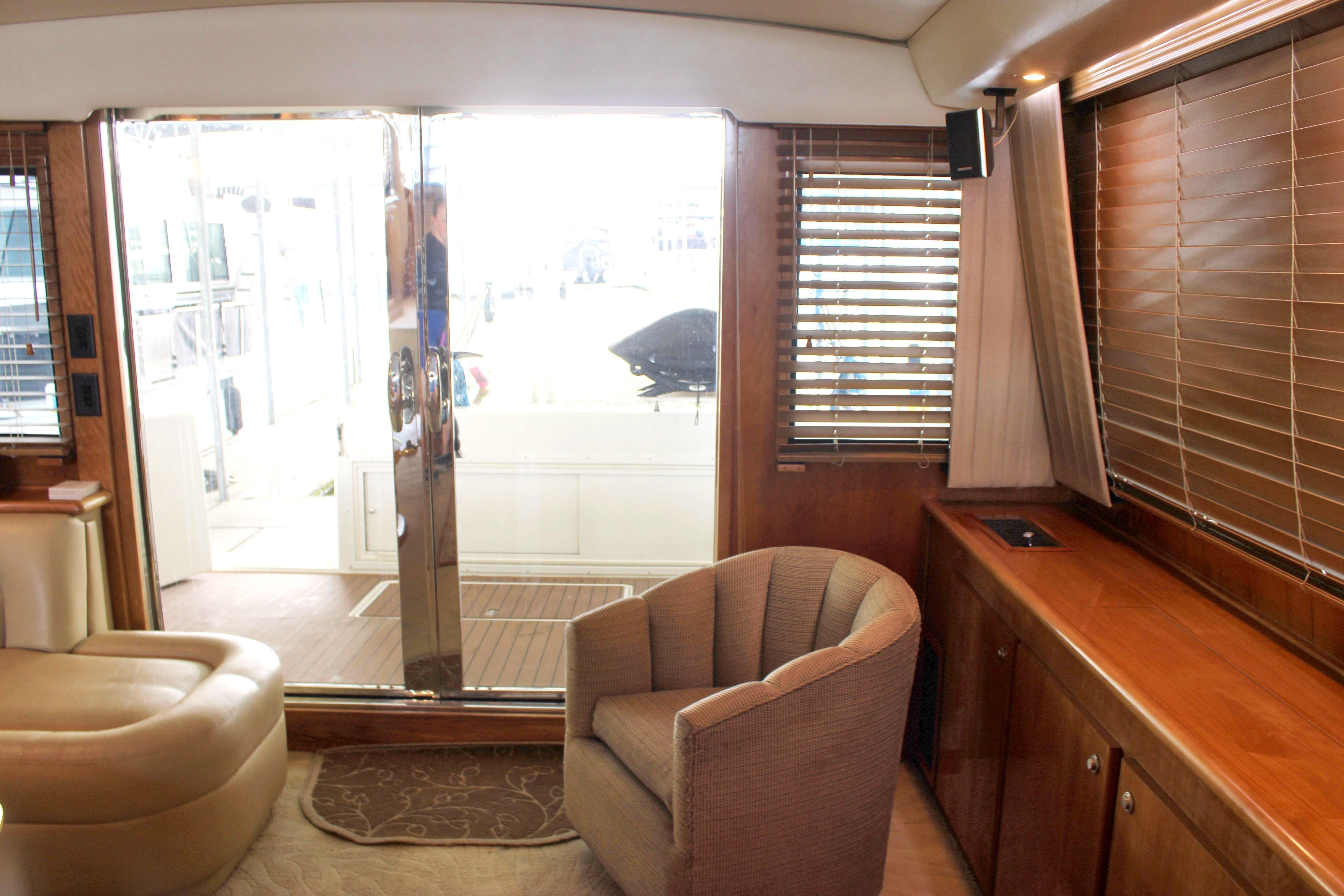 Luxurious interior of a 2007 Navigator 5100 yacht with elegant furnishings and marina view.
