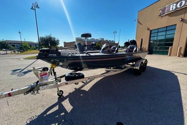 2025 Ranger ALPHA 208 boat on trailer outside a building under clear blue sky.