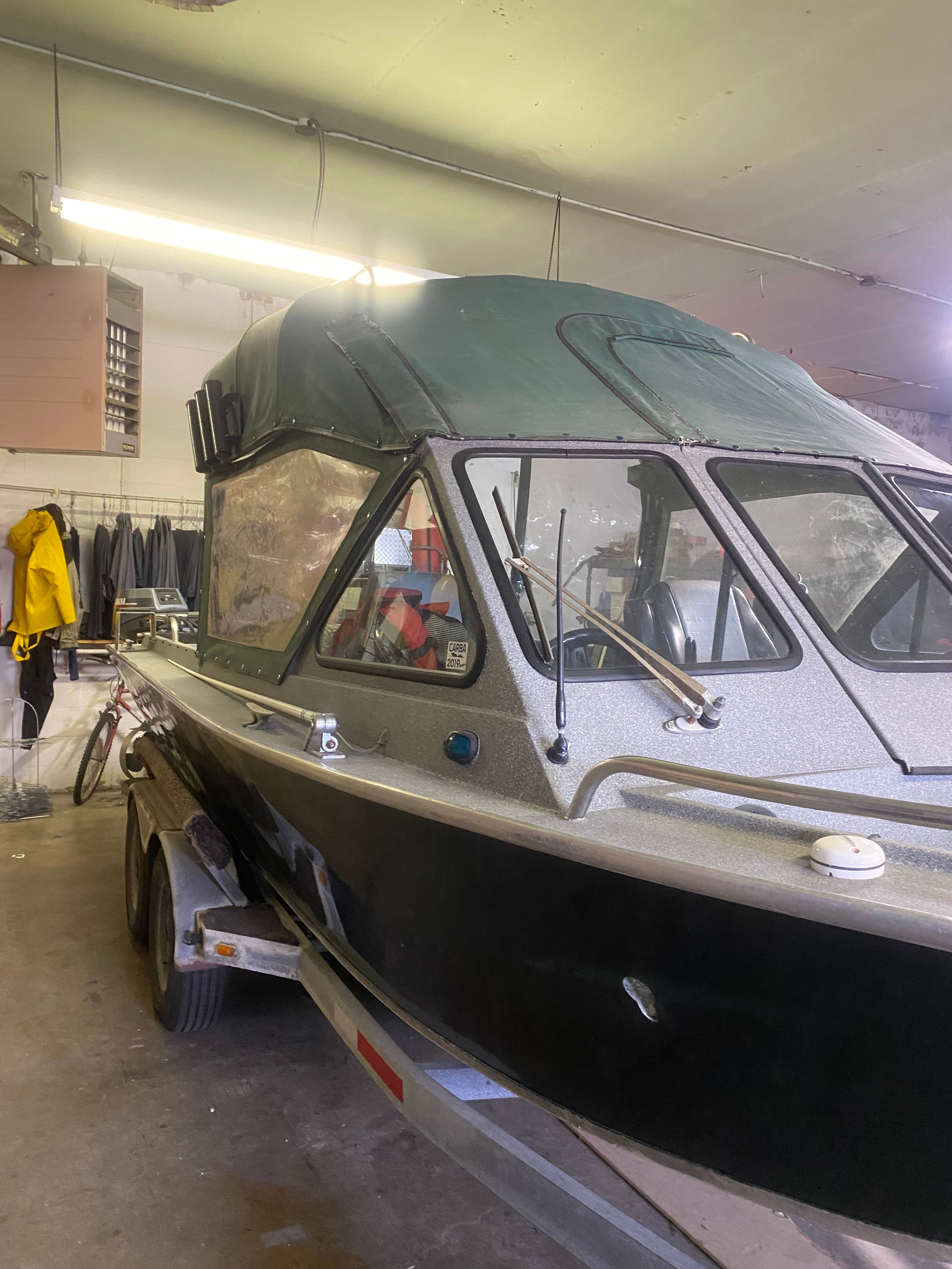 1993 Jetcraft Fastwater boat in a workshop on a trailer.