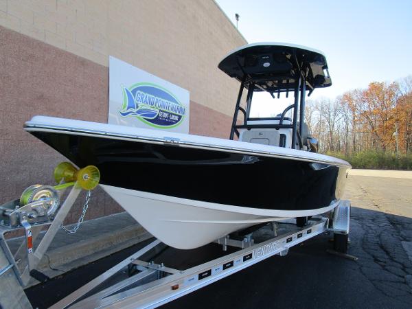 2025 Sea Pro 230 Bay boat on trailer, displayed outdoors.