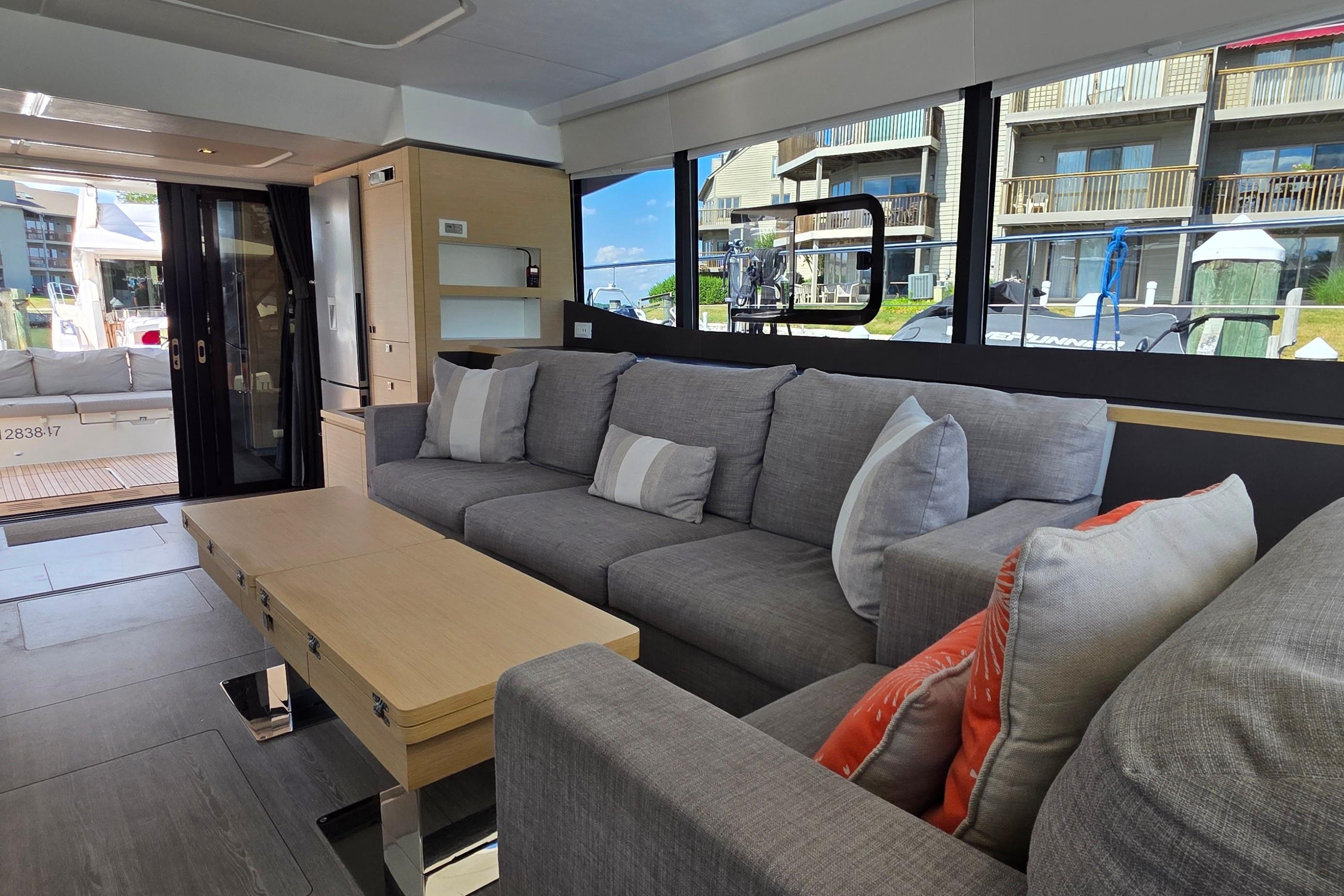 Luxurious interior of 2018 Fountaine Pajot Motor Yacht 44 with modern gray seating.